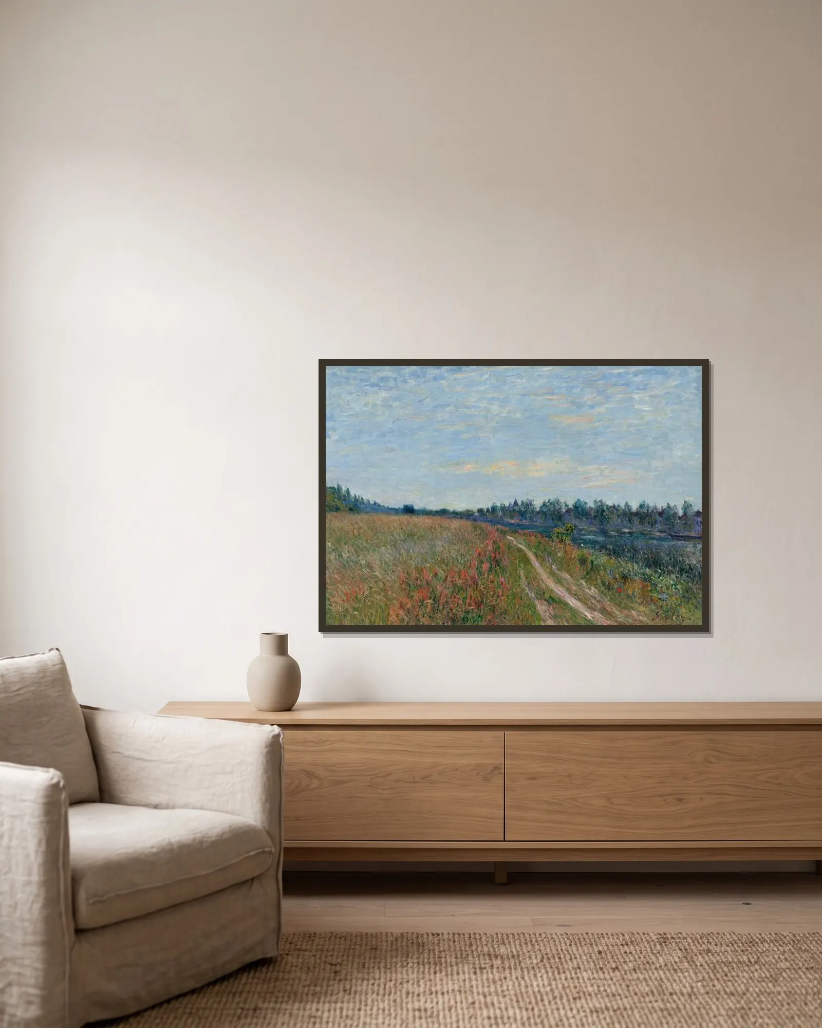 La prairie av Alfred Sisley inramad på en vägg