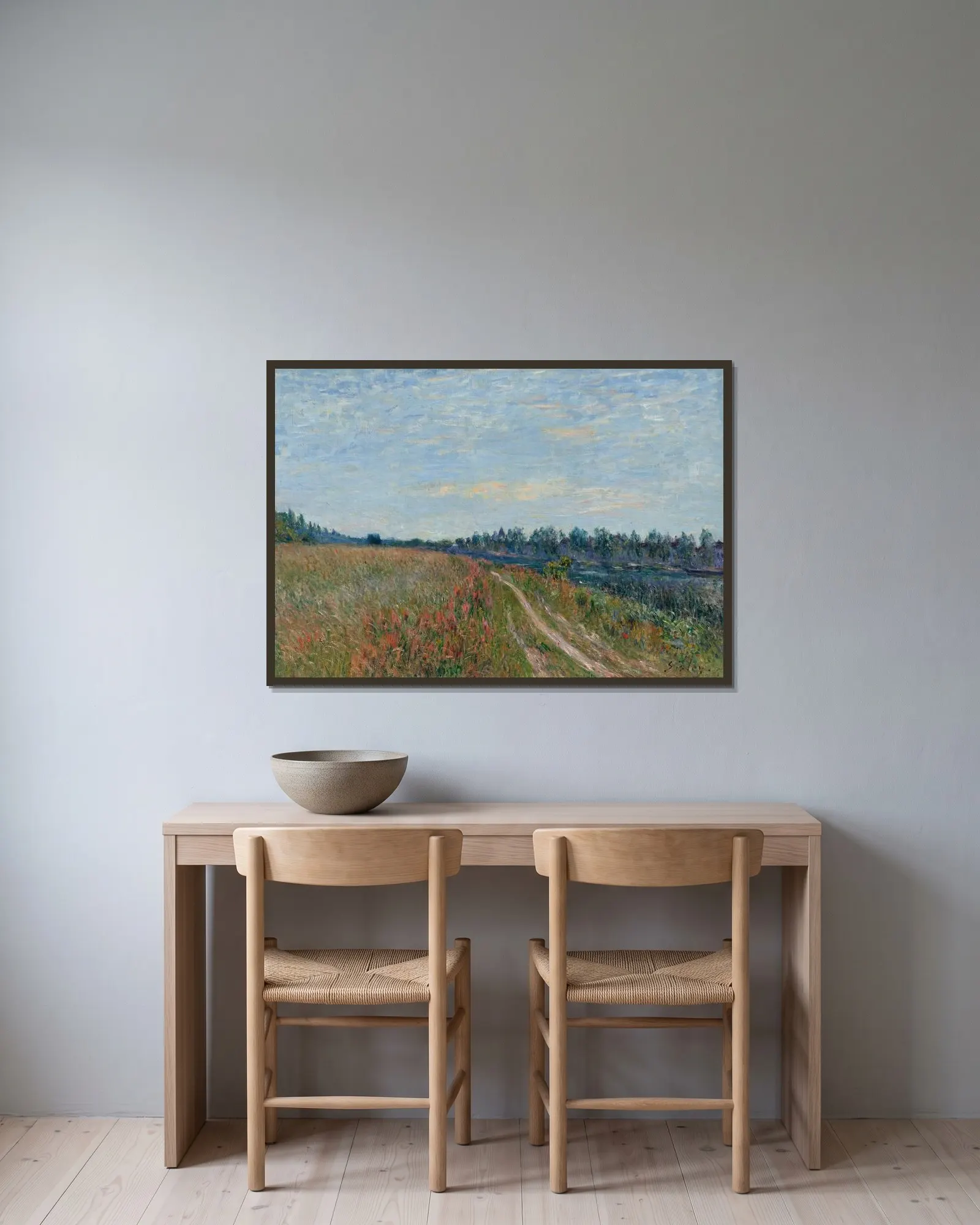 La prairie av Alfred Sisley inramad på en vägg