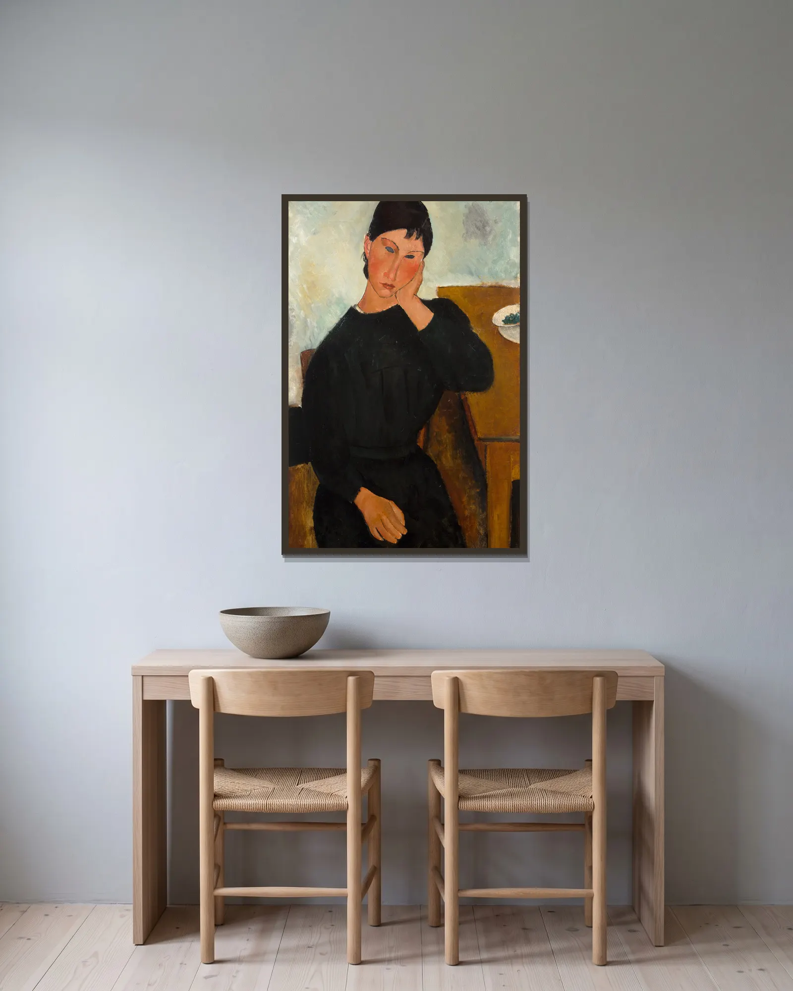 Elvira Resting at a Table av Amedeo Modigliani inramad på en vägg