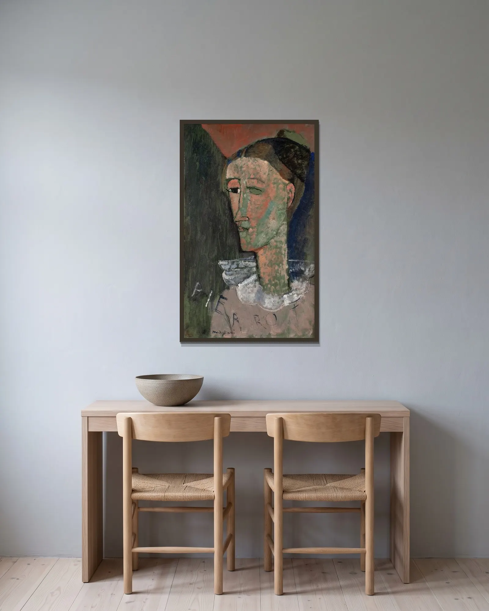 Self-Portrait as Pierrot av Amedeo Modigliani inramad på en vägg