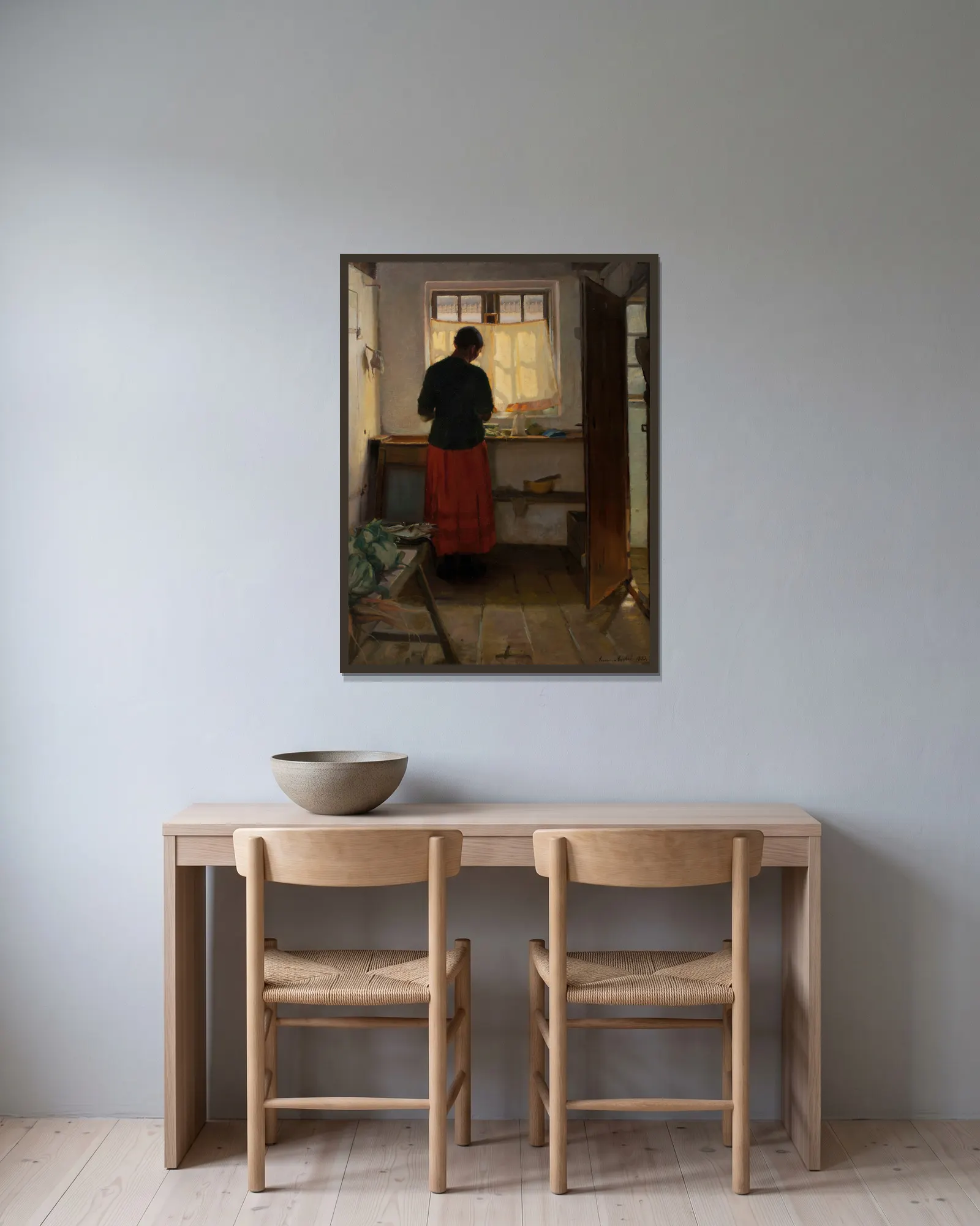 The maid in the kitchen av Anna Ancher inramad på en vägg