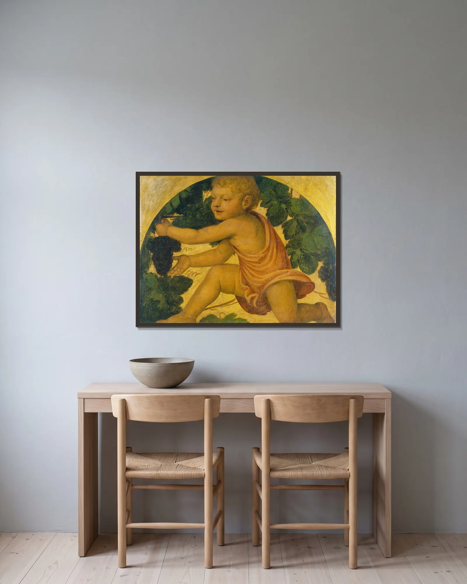 Putto picking Grapes av Bernardino Luini inramad på en vägg