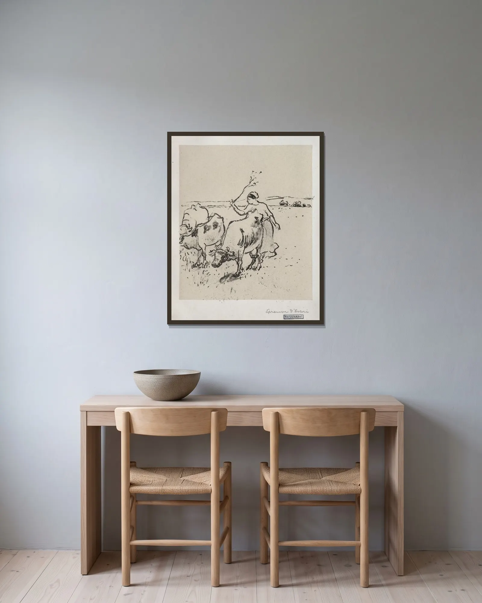 Cowherder av Camille Pissarro inramad på en vägg