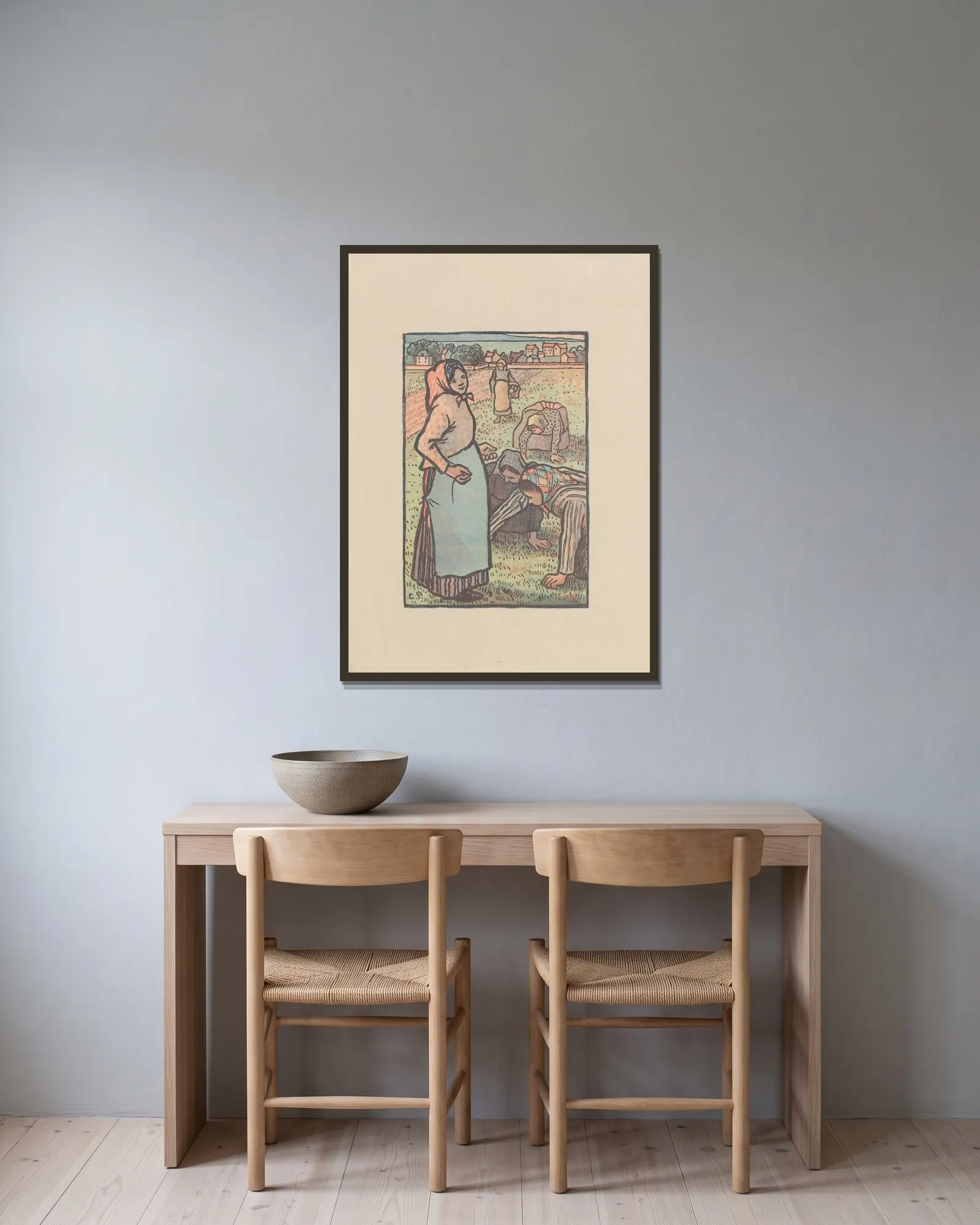 Les sarcleuses av Camille Pissarro inramad på en vägg