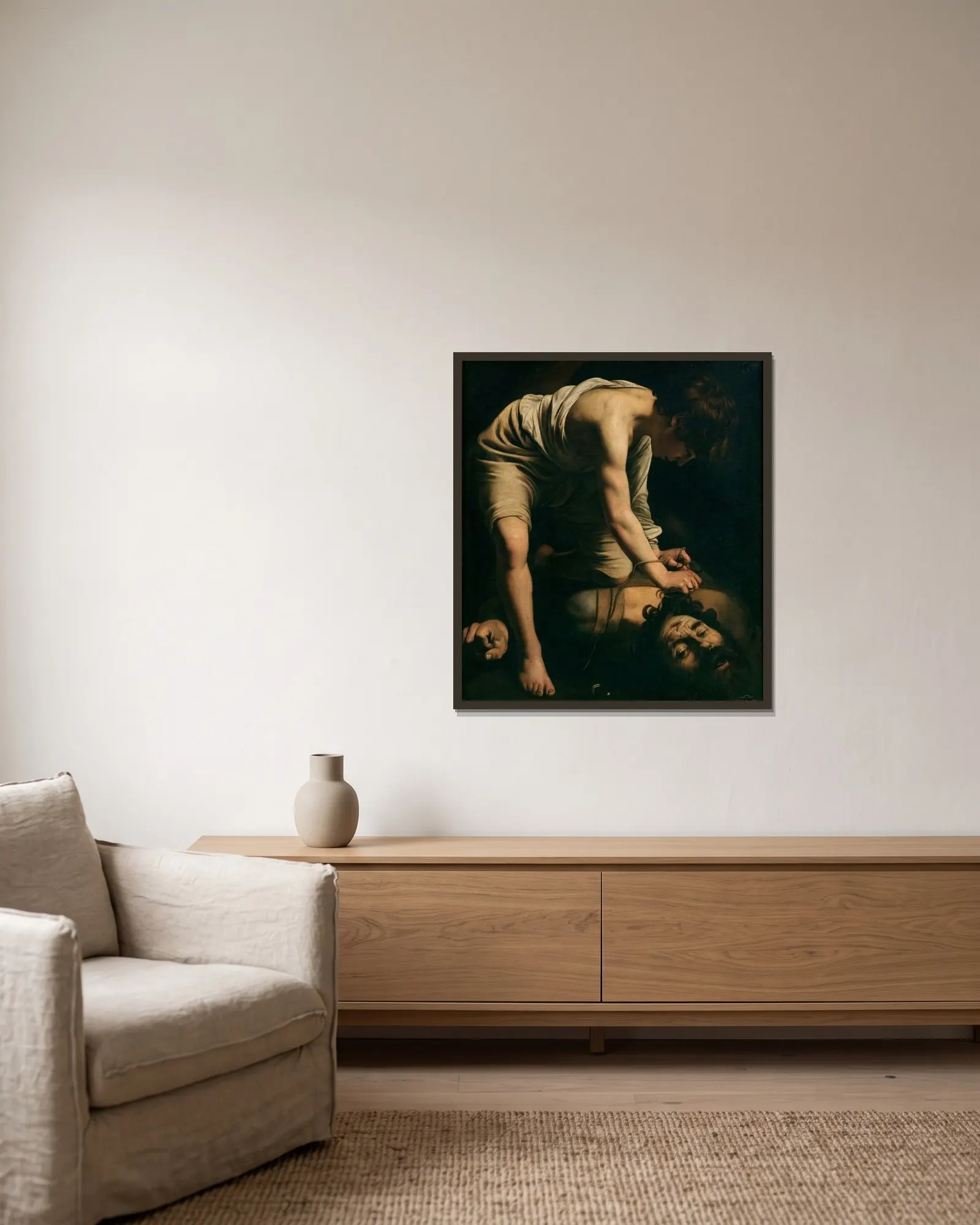David and Goliath av Caravaggio inramad på en vägg