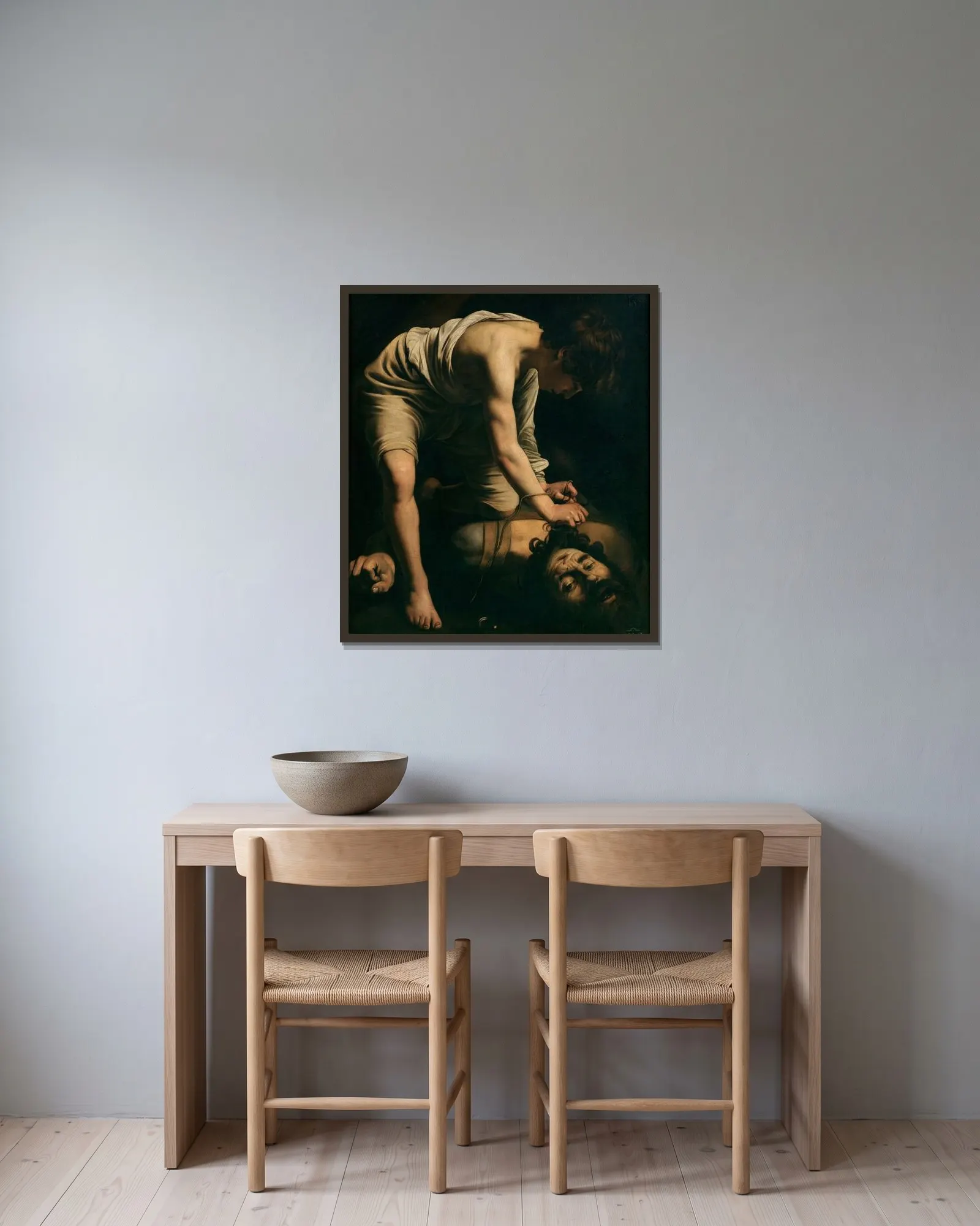 David and Goliath av Caravaggio inramad på en vägg