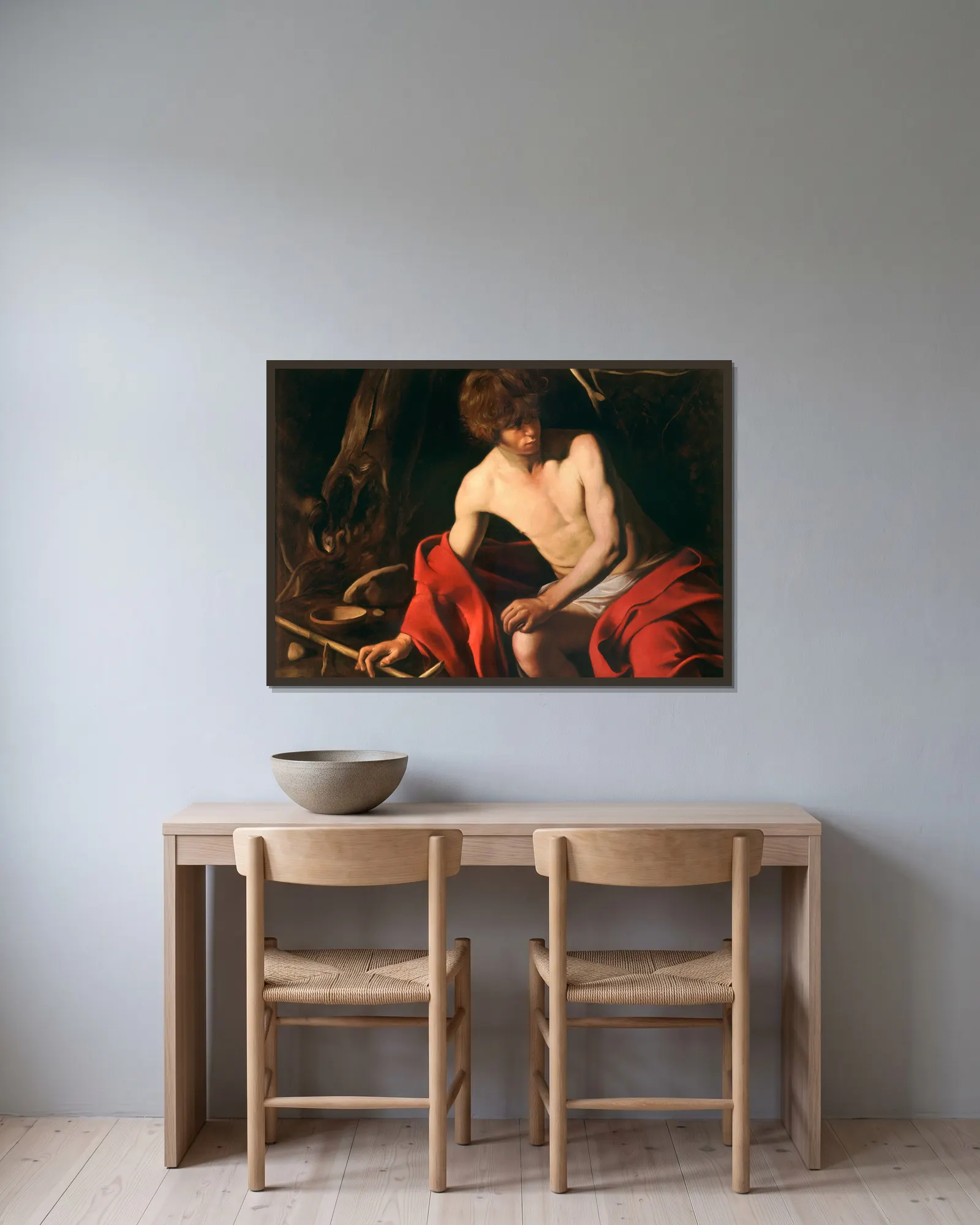 Saint John the Baptist av Caravaggio inramad på en vägg