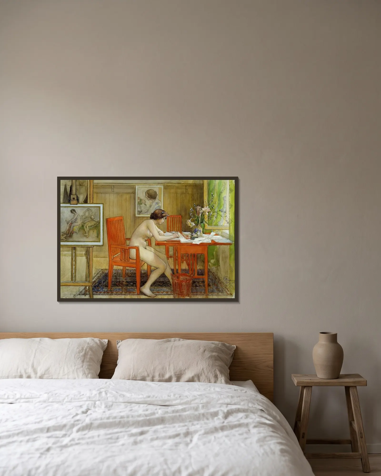 Modellen skriver ett vykort av Carl Larsson inramad på en vägg