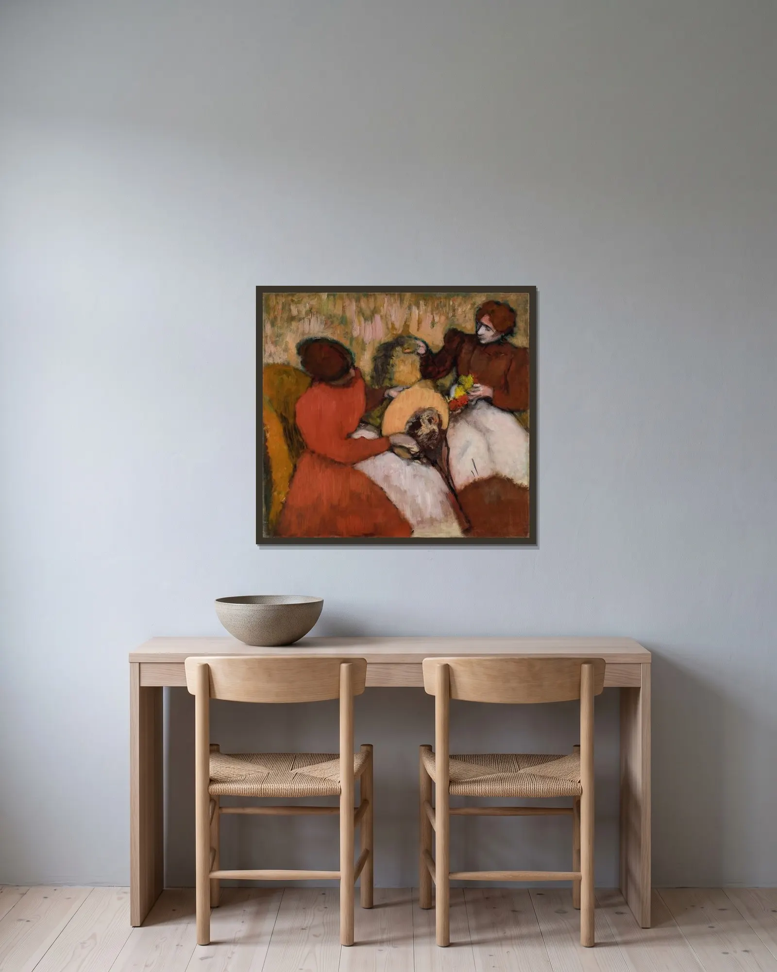 The Milliners av Edgar Degas inramad på en vägg