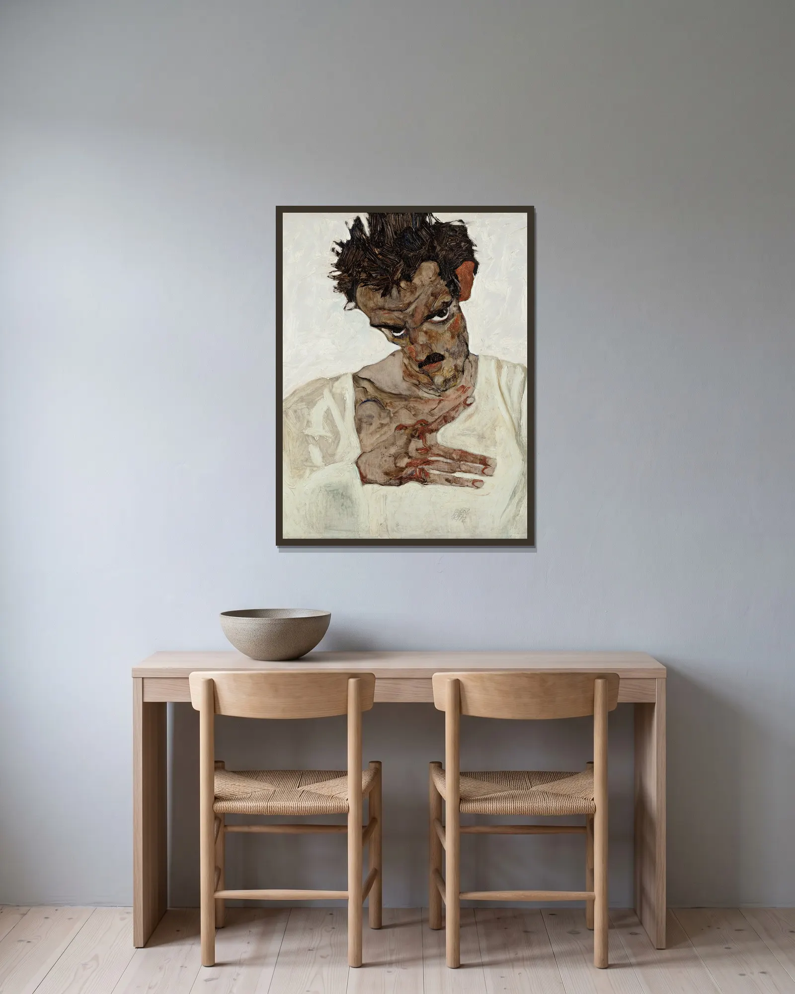 Self-Portrait With Lowered Head av Egon Schiele inramad på en vägg
