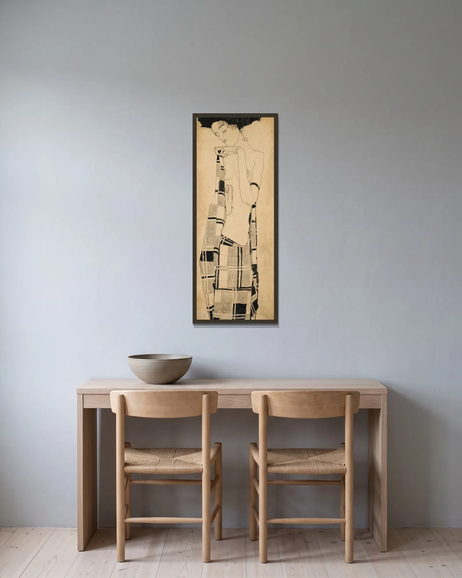 Standing Girl av Egon Schiele inramad på en vägg