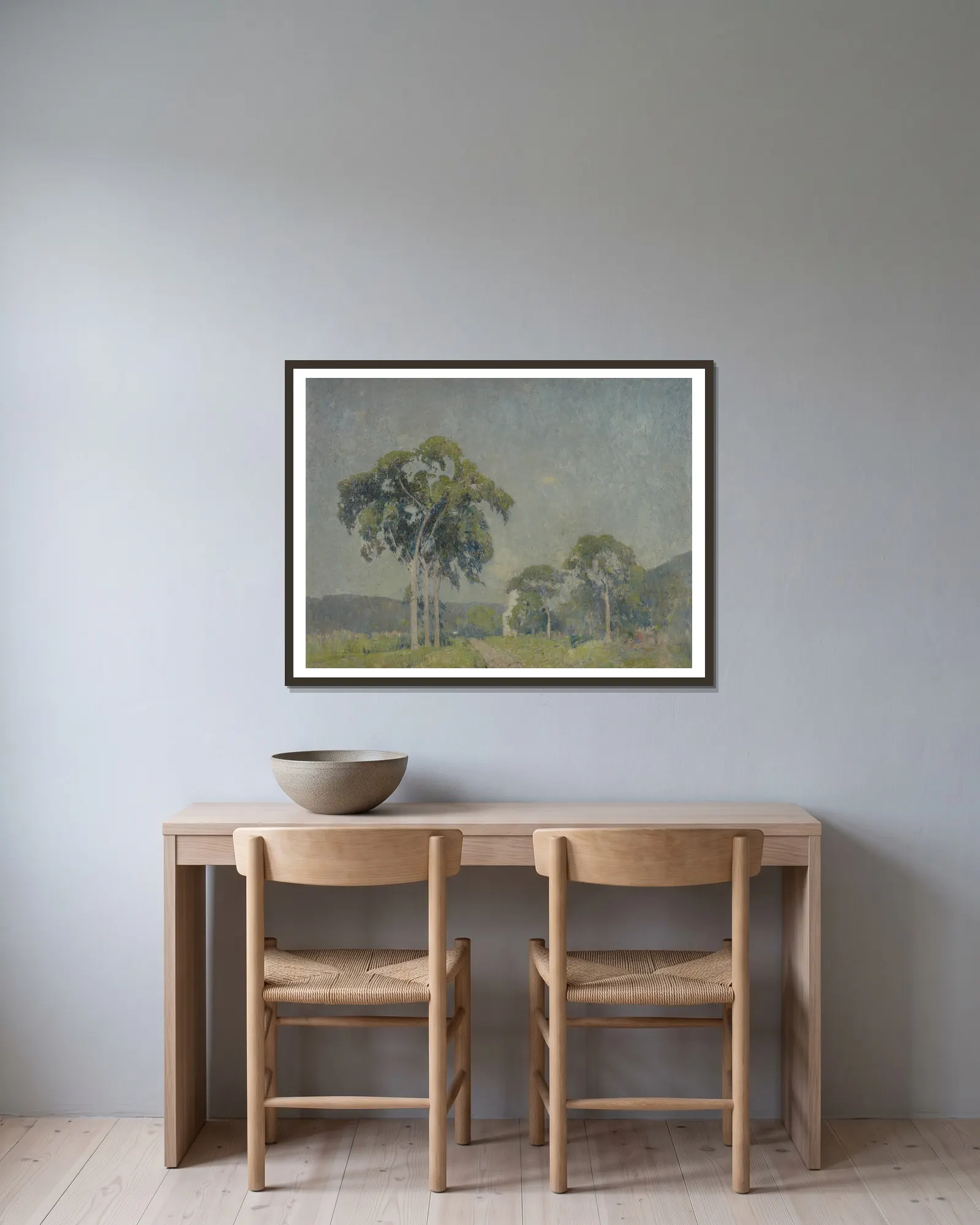 Landscape with Trees av Emil Carlsen inramad på en vägg