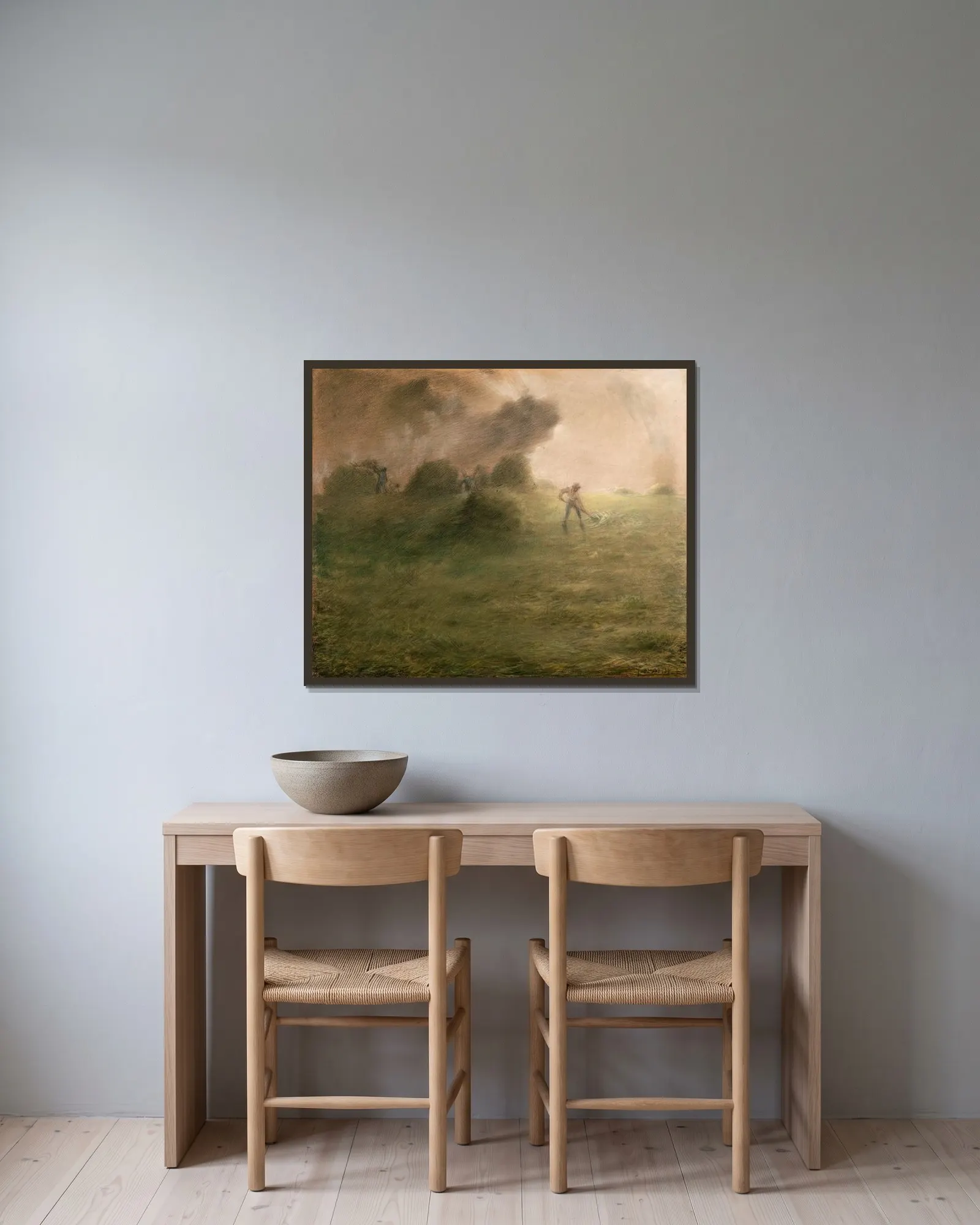A Storm during Haymaking av Jean-François Millet inramad på en vägg