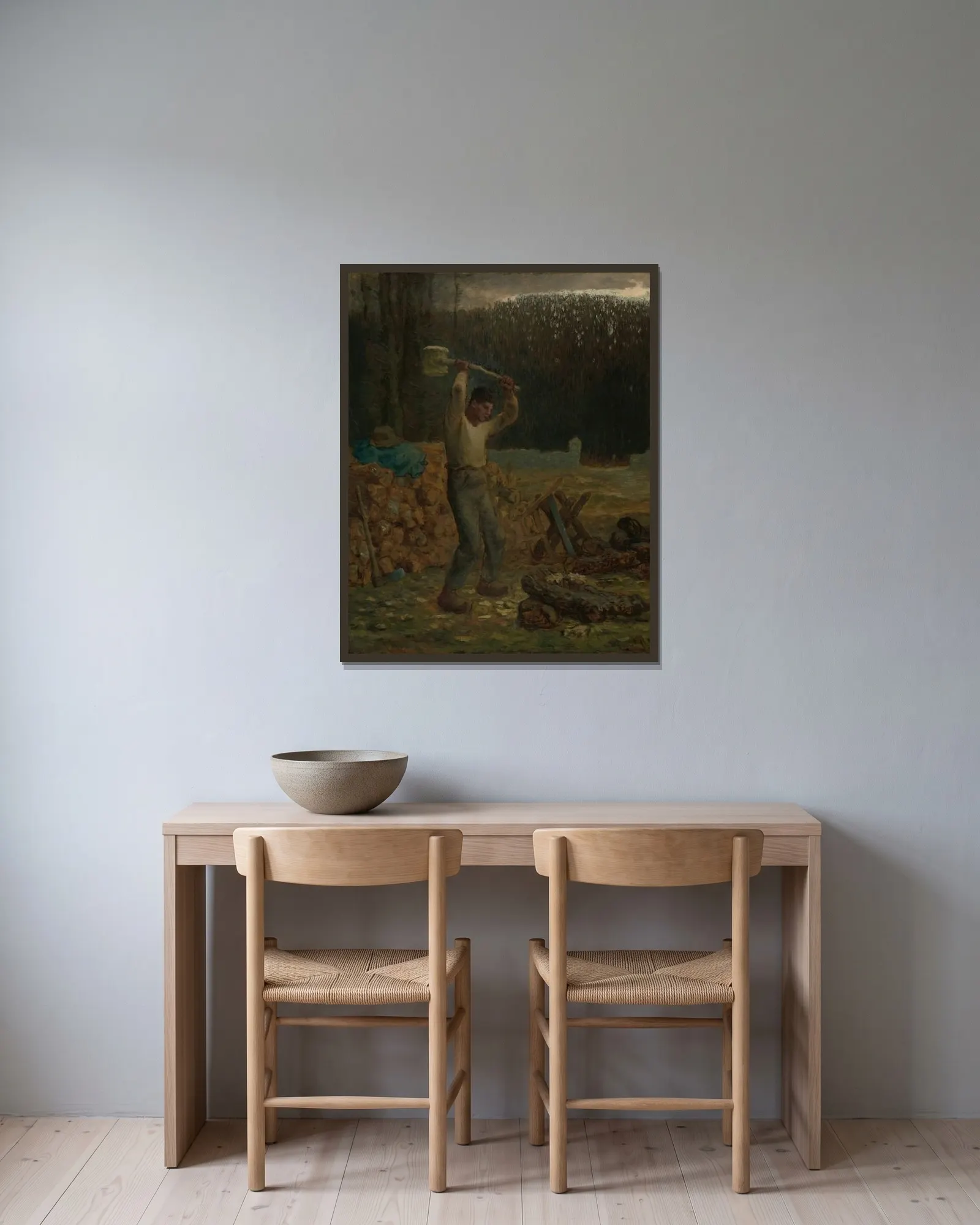 The Woodchopper av Jean-François Millet inramad på en vägg