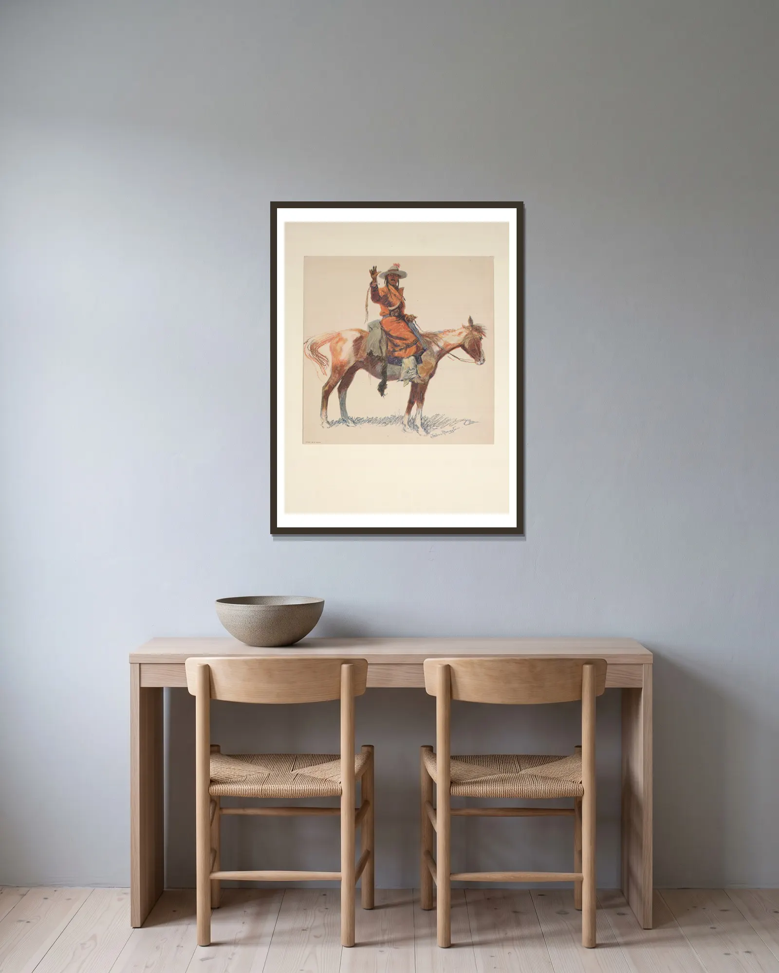 An Apache scout av Frederic Remington inramad på en vägg