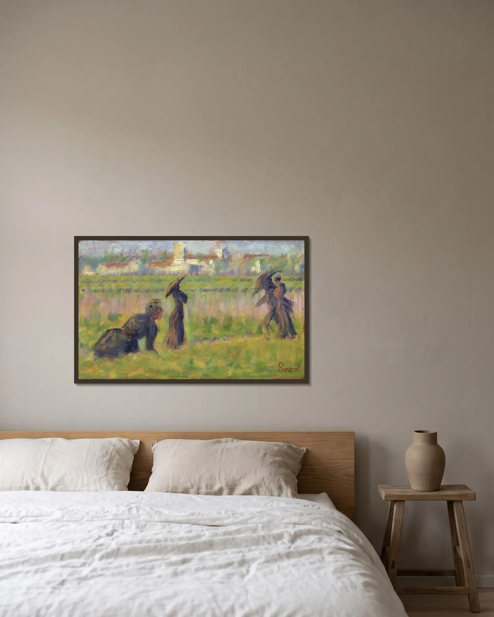 Figures in a Landscape av Georges Seurat inramad på en vägg
