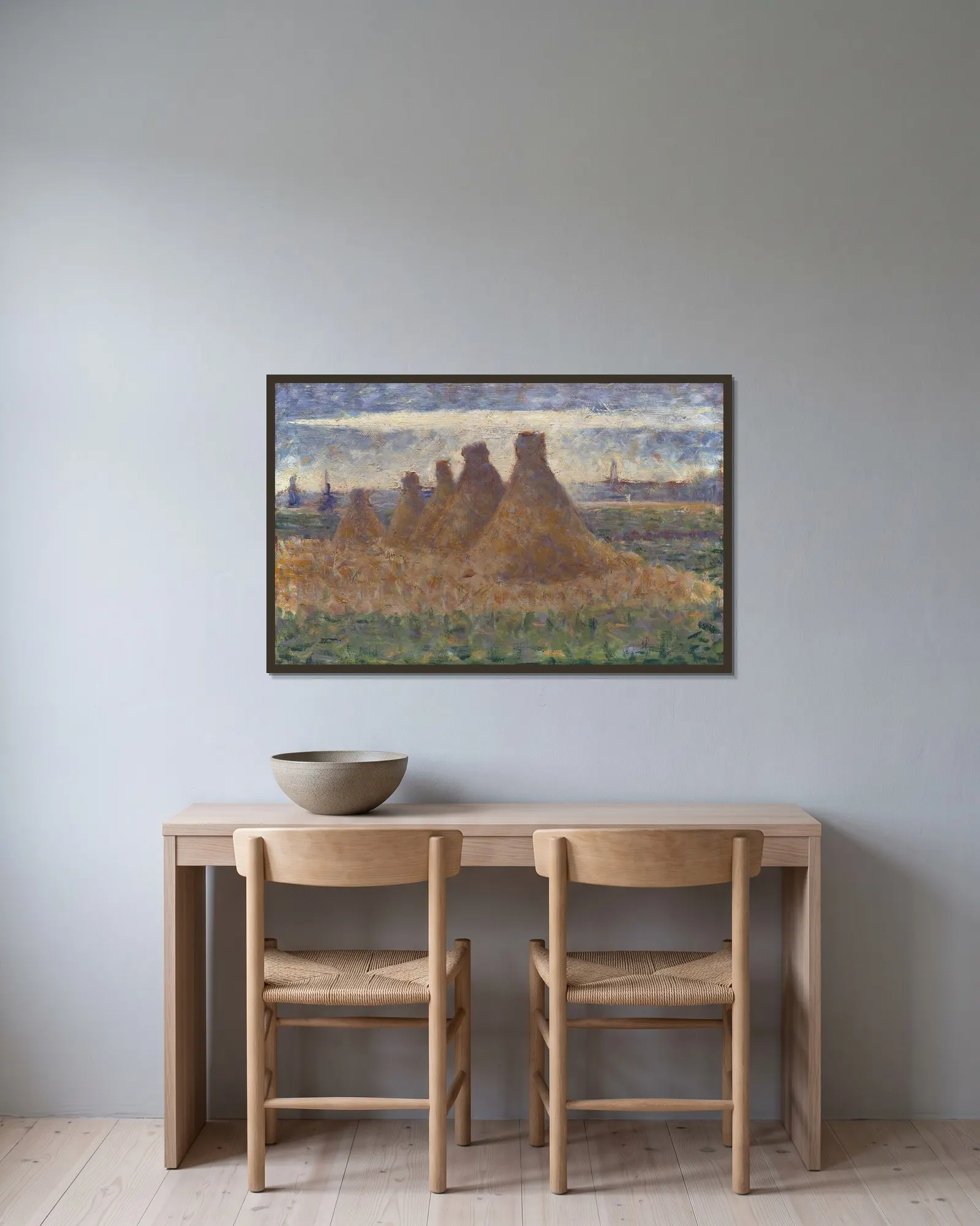 Haystacks av Georges Seurat inramad på en vägg