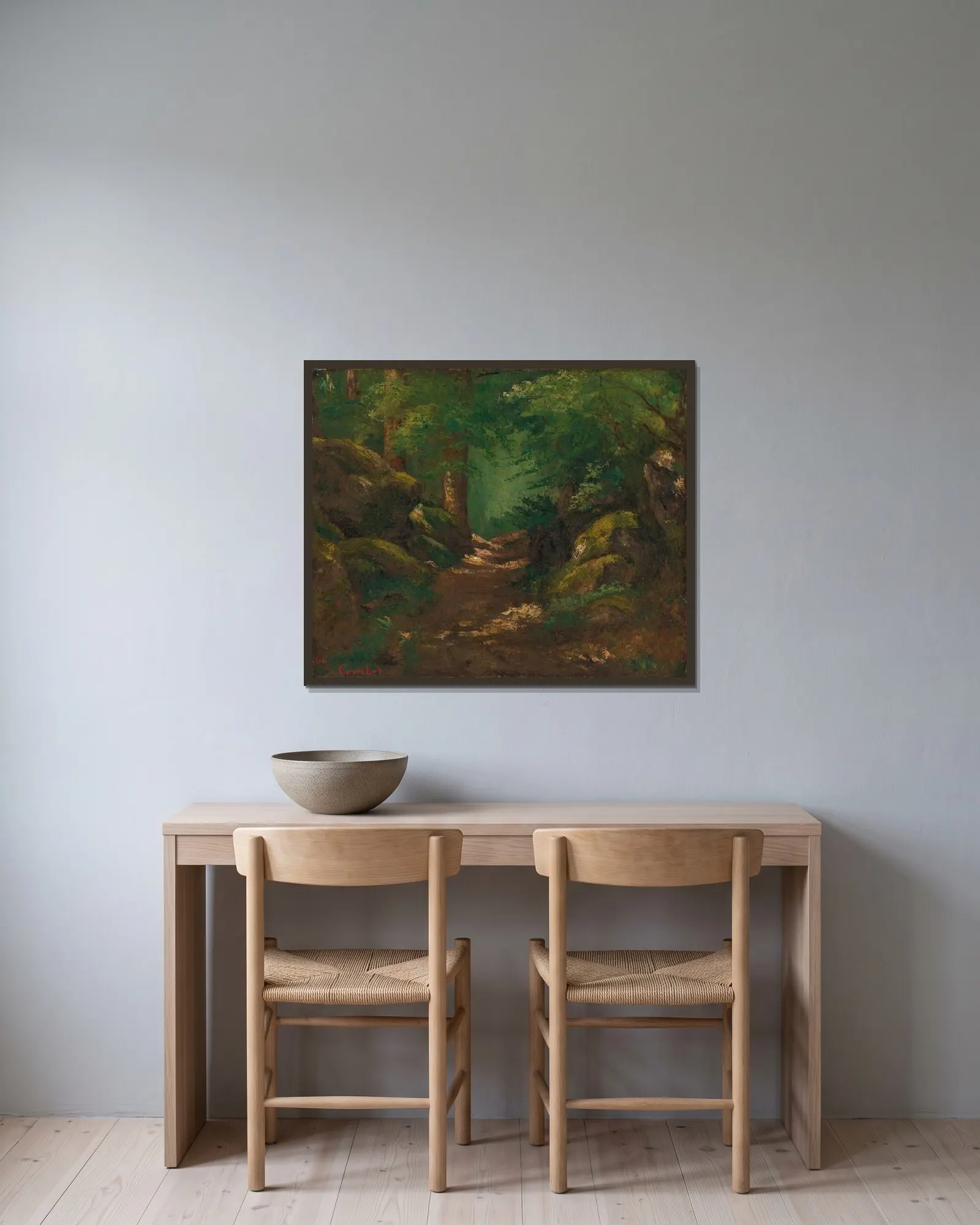 La Clairière av Gustave Courbet inramad på en vägg