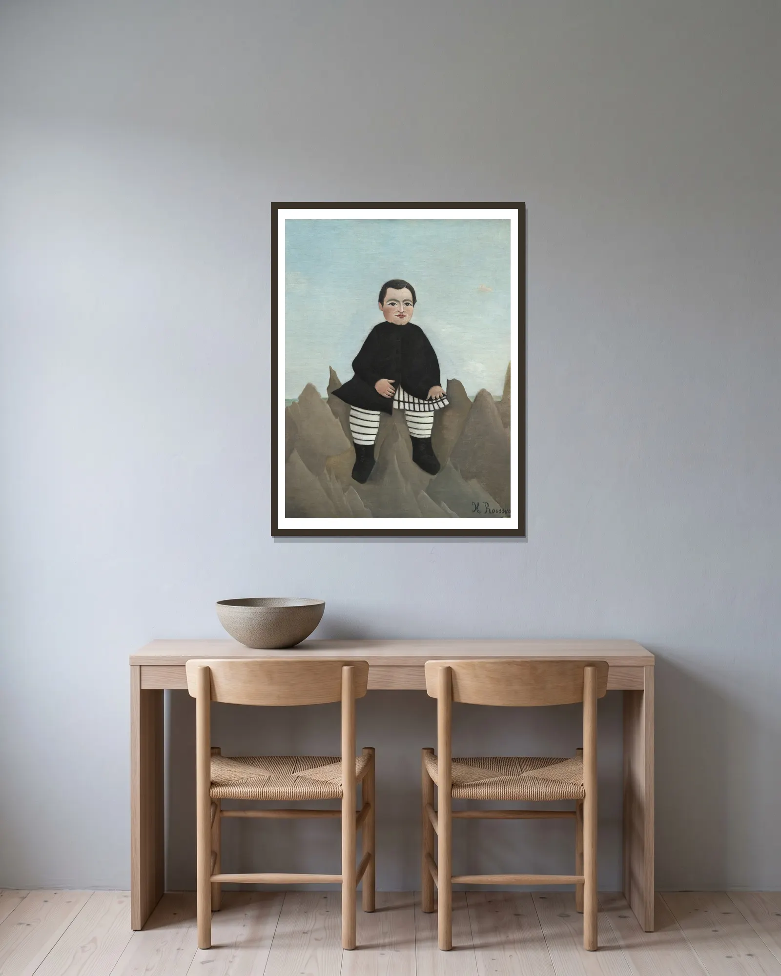 Boy on the Rocks av Henri Rousseau inramad på en vägg