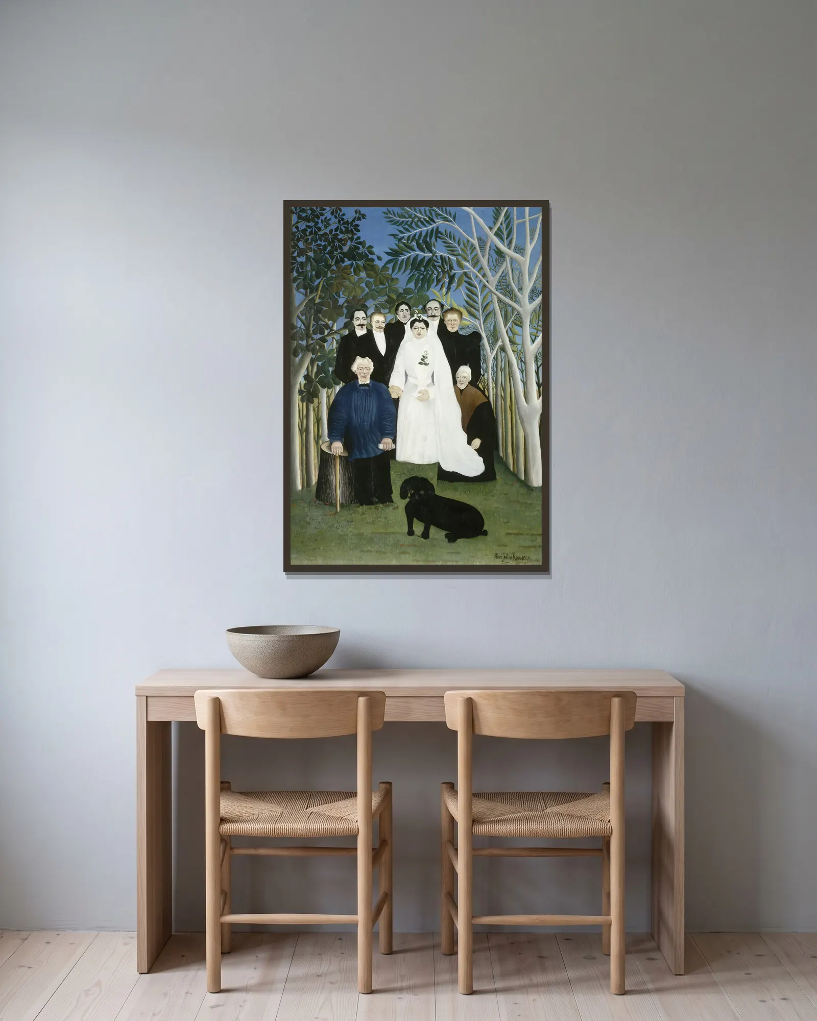 The Wedding Party av Henri Rousseau inramad på en vägg