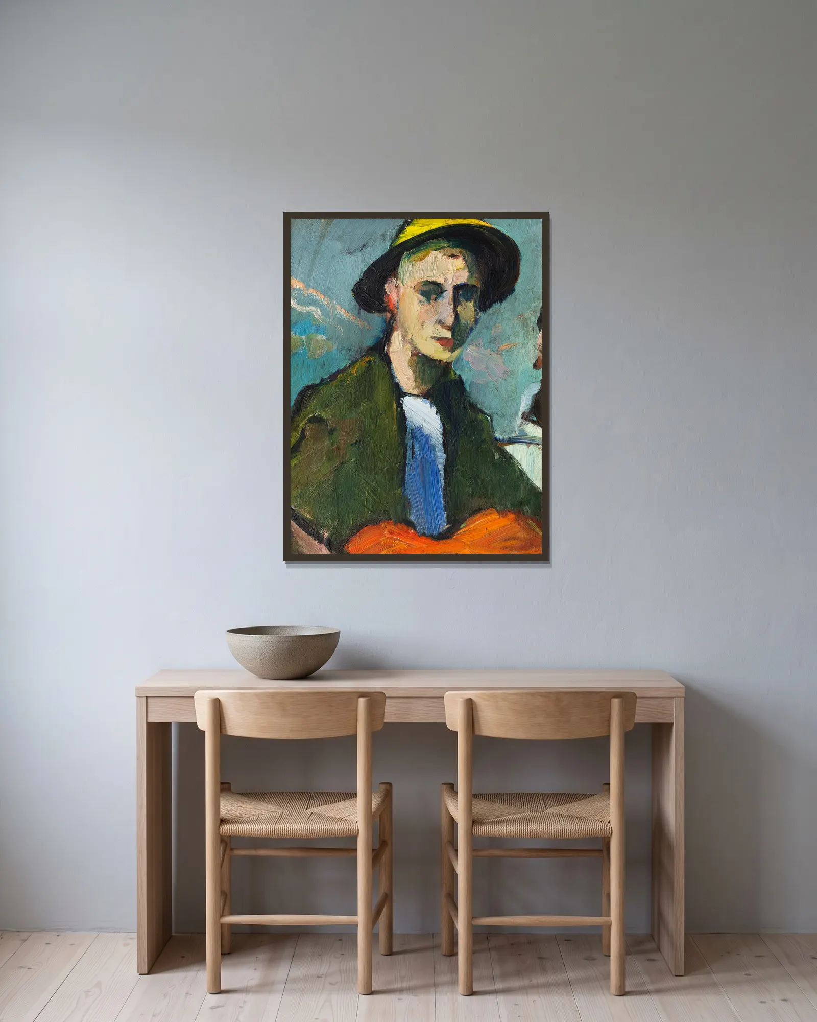 Selbstbildnis mit gelbem Hut av Hermann Stenner inramad på en vägg
