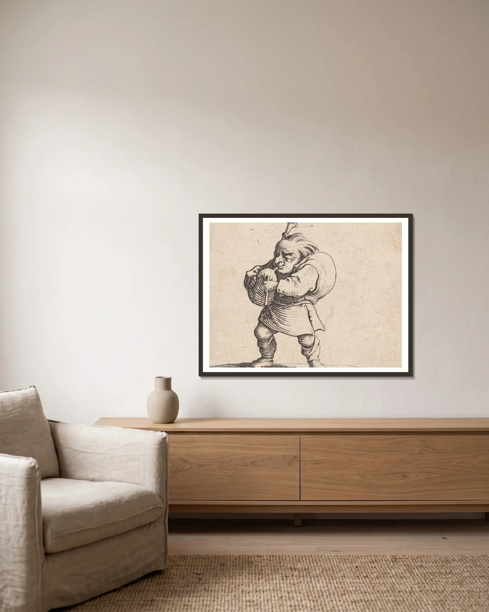 La jouer de cornemuse av Jacques Callot inramad på en vägg