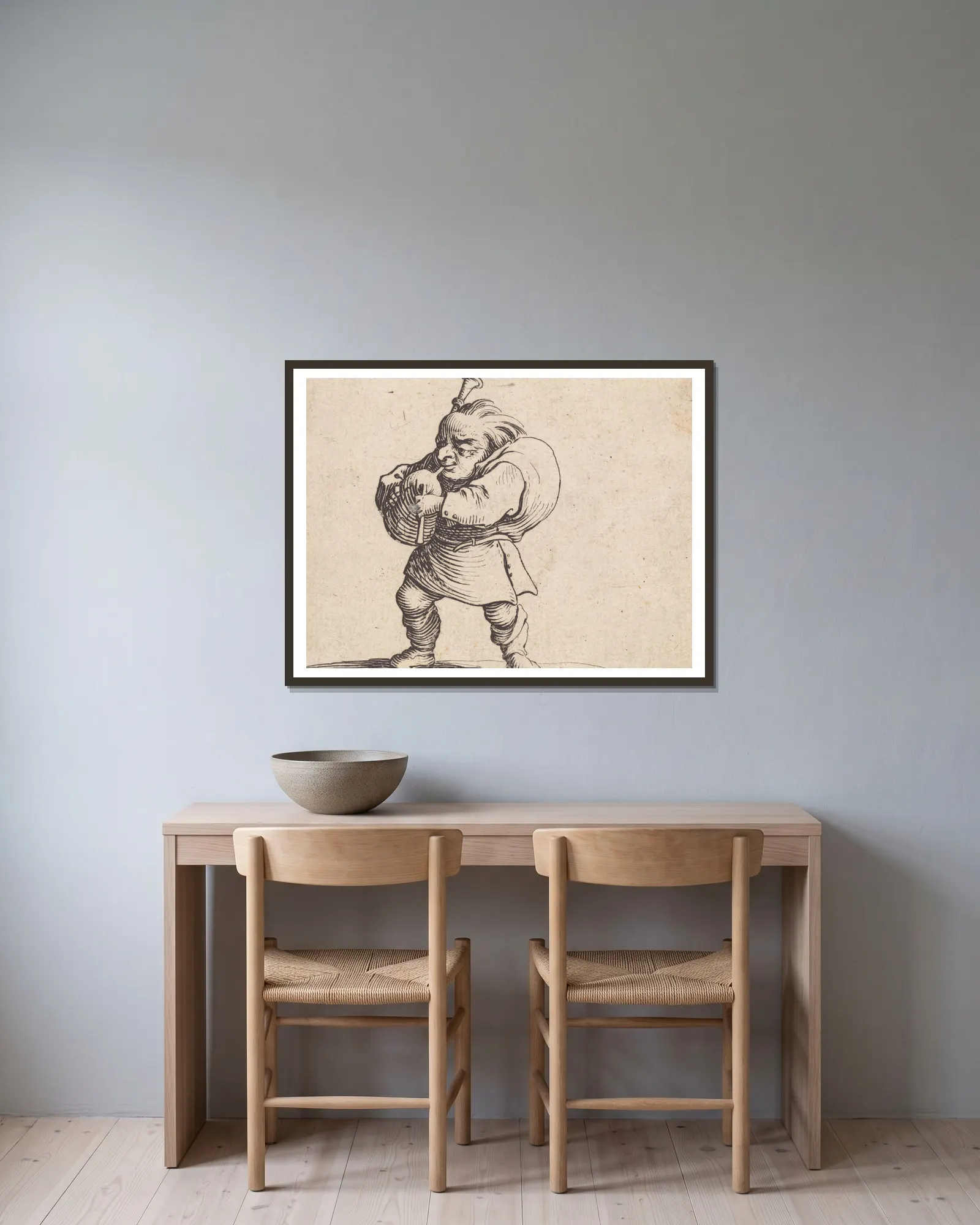 La jouer de cornemuse av Jacques Callot inramad på en vägg