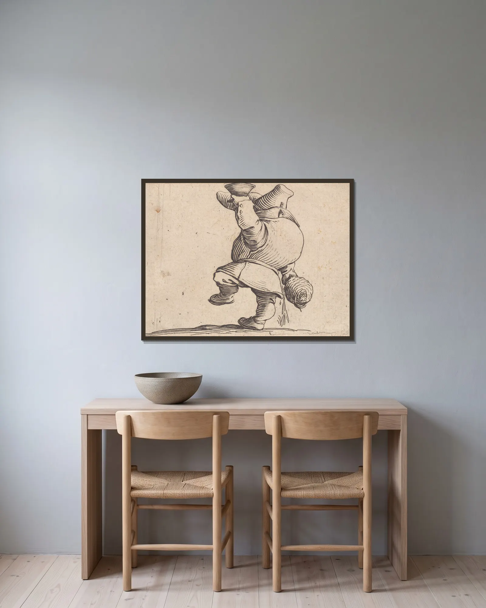 Le buveur vu de dos av Jacques Callot inramad på en vägg
