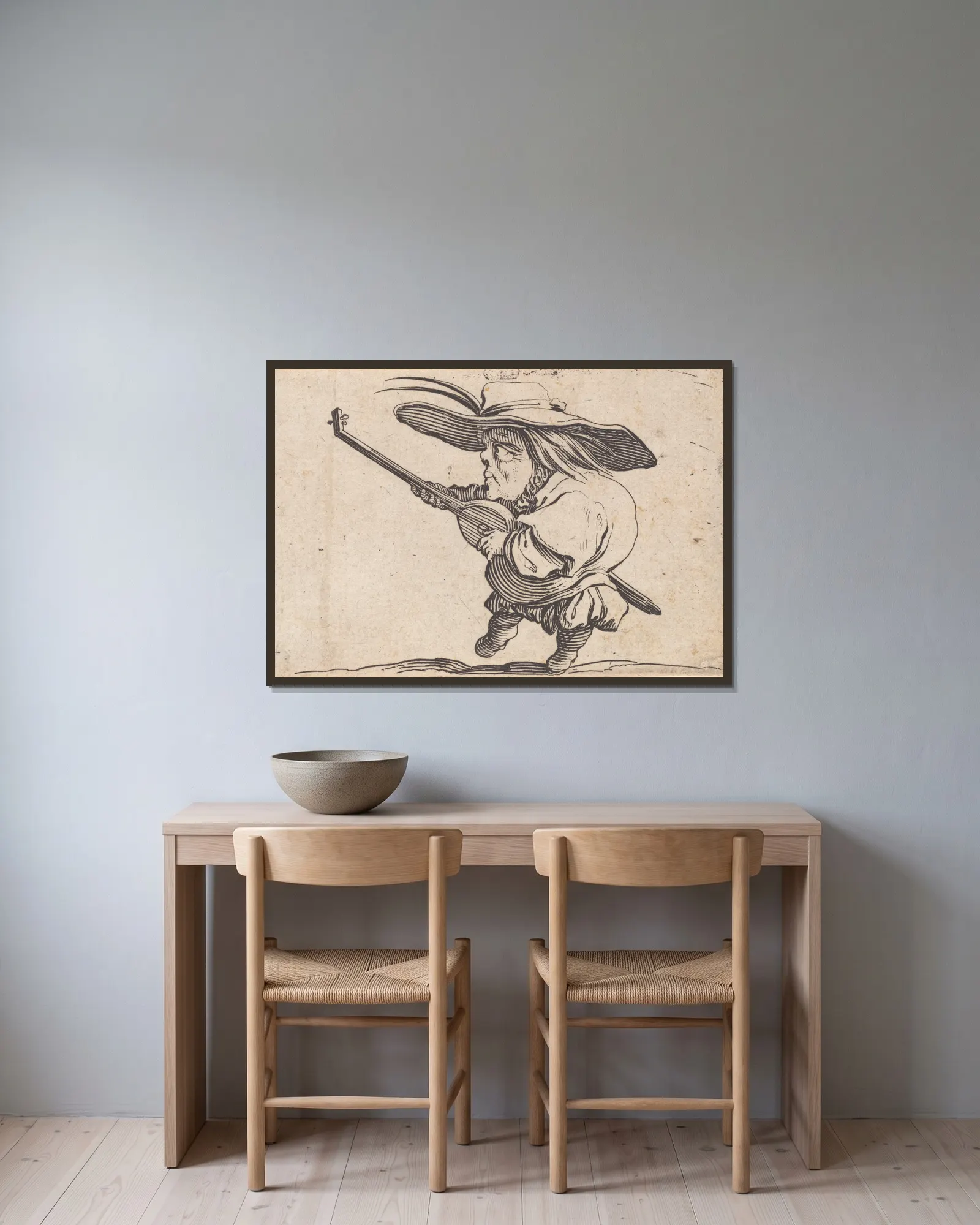 Le joeuer de luth av Jacques Callot inramad på en vägg
