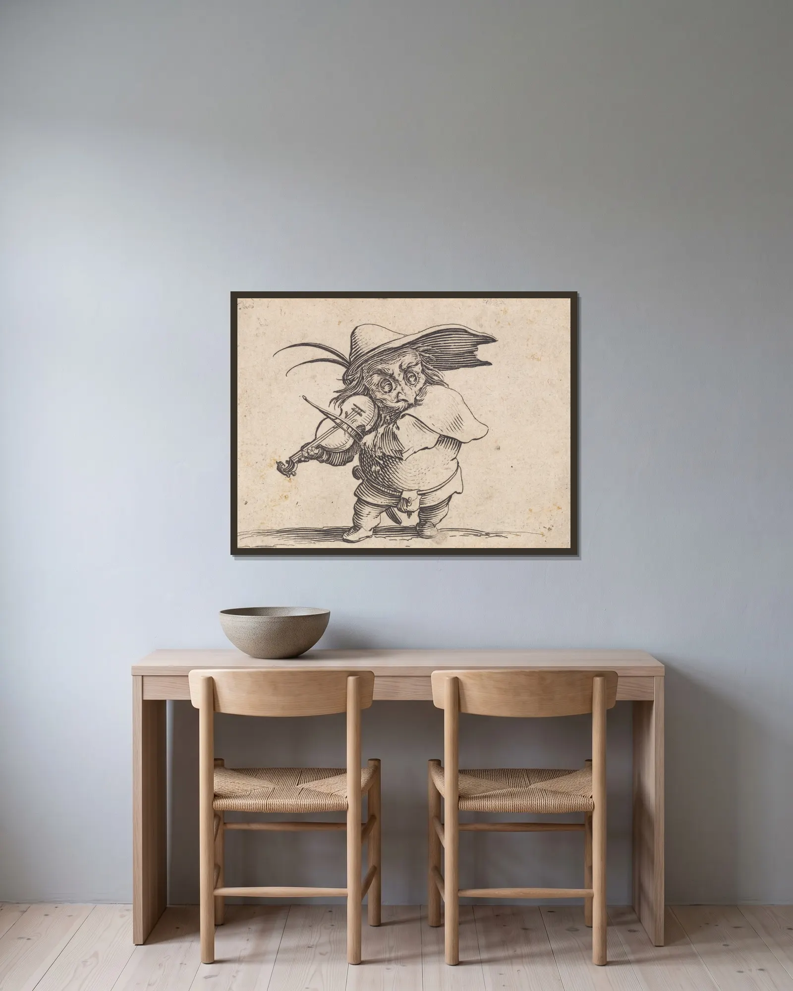 Le joueur de violon av Jacques Callot inramad på en vägg