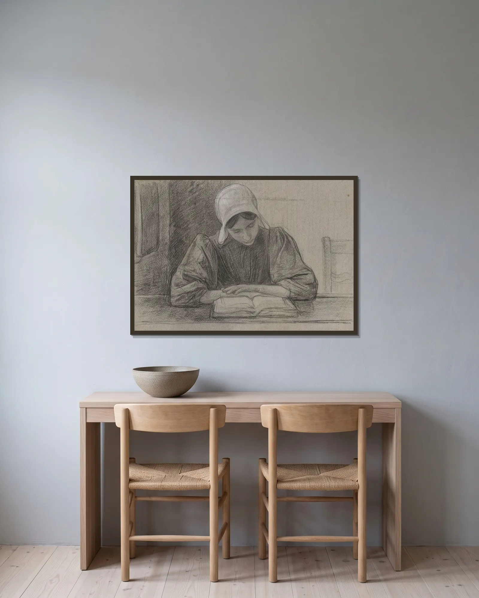 Lezend meisje met kap av Jan Veth inramad på en vägg