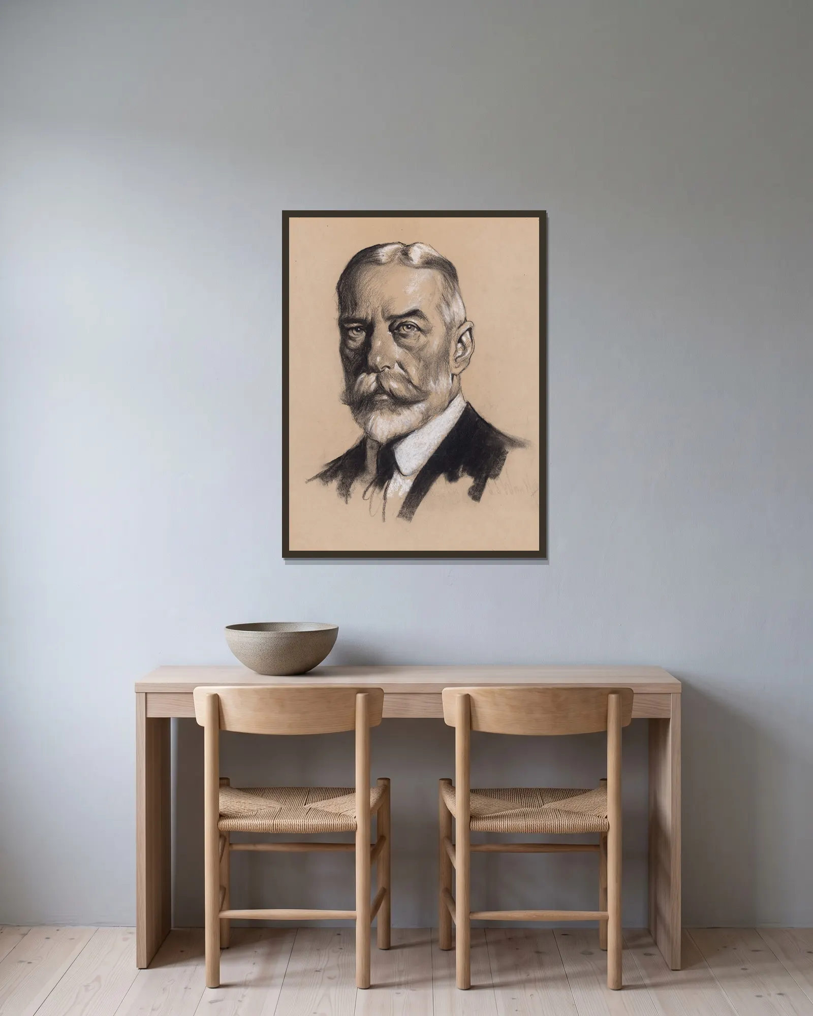 King George V av Samuel Johnson Woolf inramad på en vägg