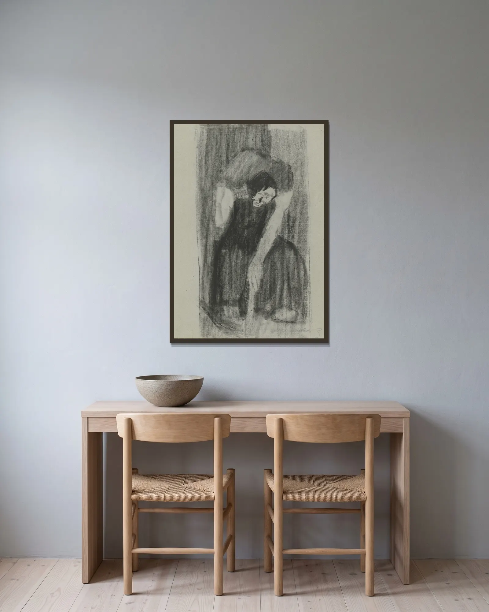 Inspiration av Käthe Kollwitz inramad på en vägg