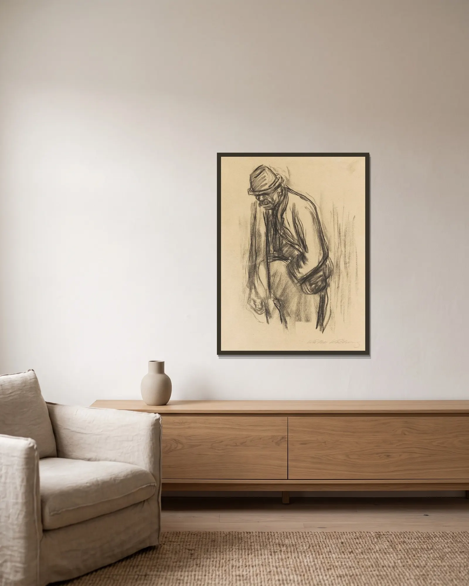Mann mit Hut av Käthe Kollwitz inramad på en vägg