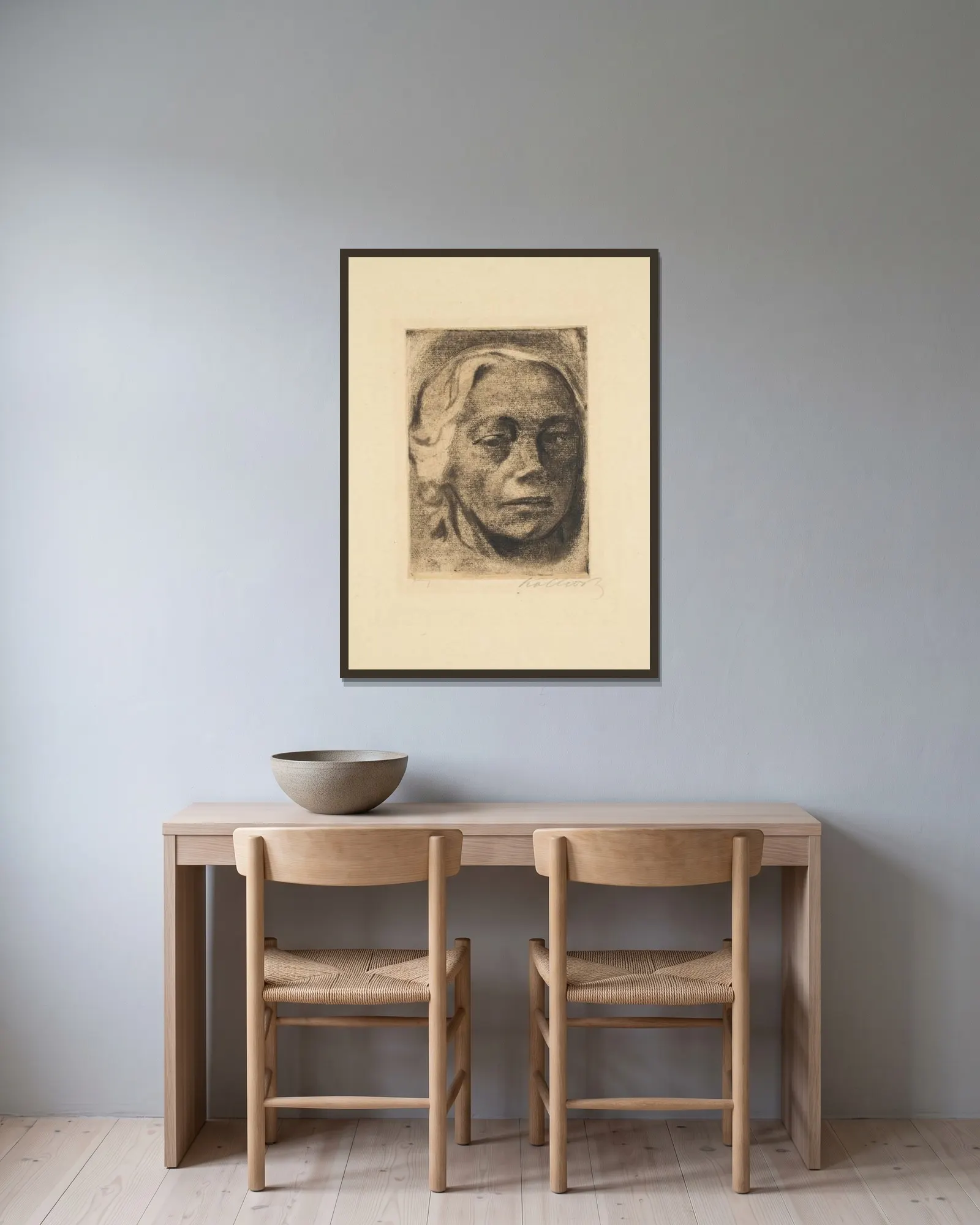 Self Portrait av Käthe Kollwitz inramad på en vägg