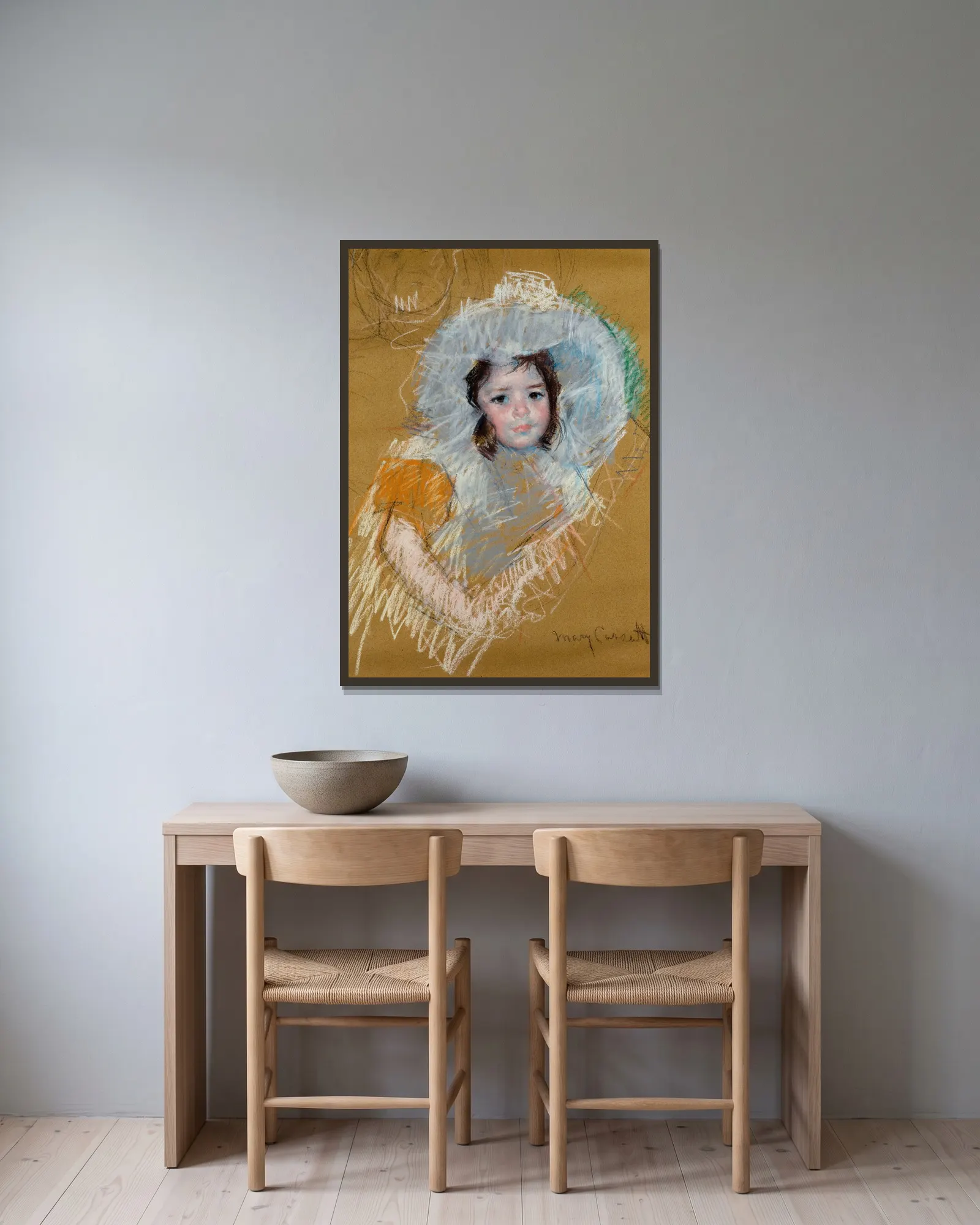 Buste de fillette av Mary Cassatt inramad på en vägg