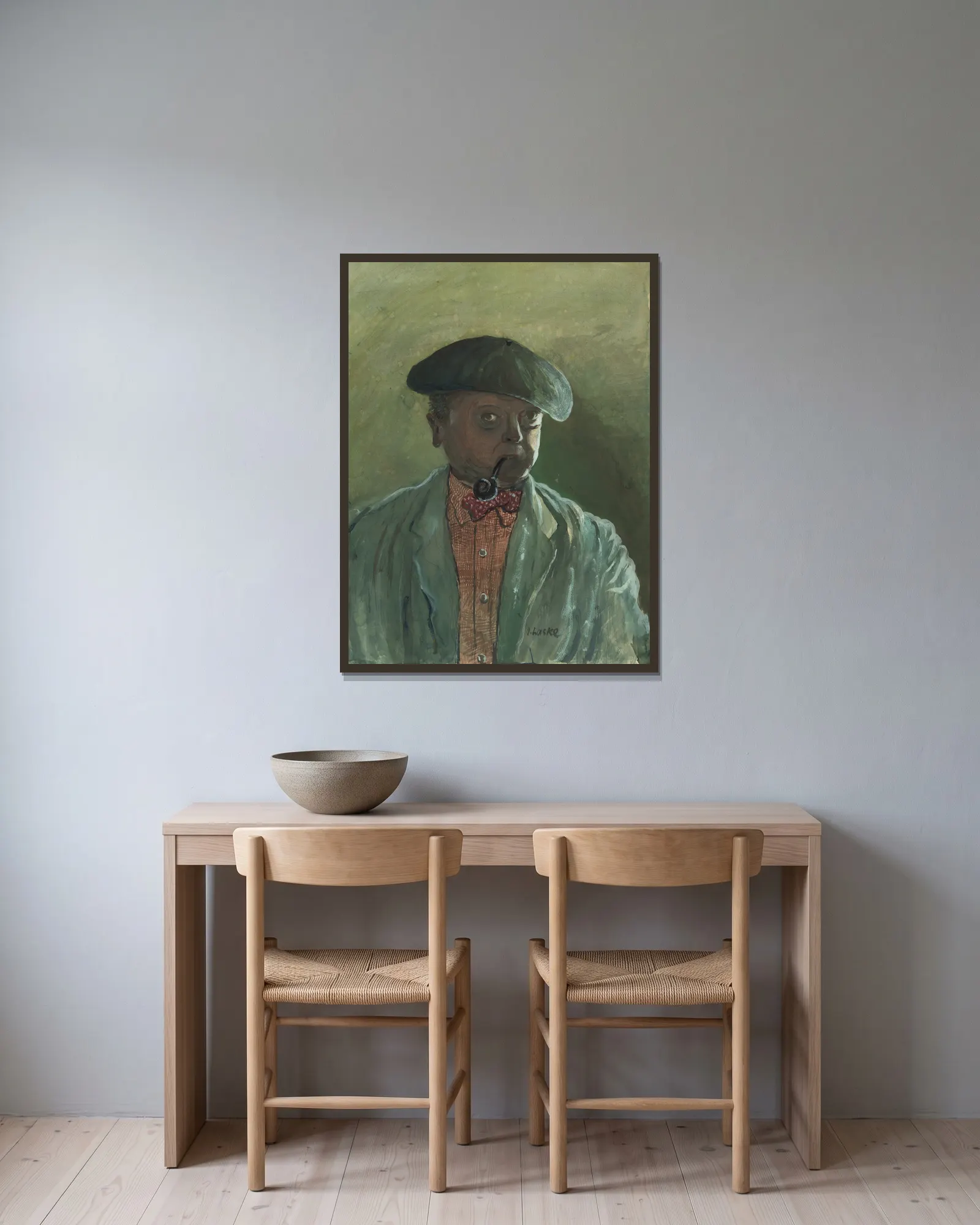 Selbstbildnis av Oskar Laske inramad på en vägg