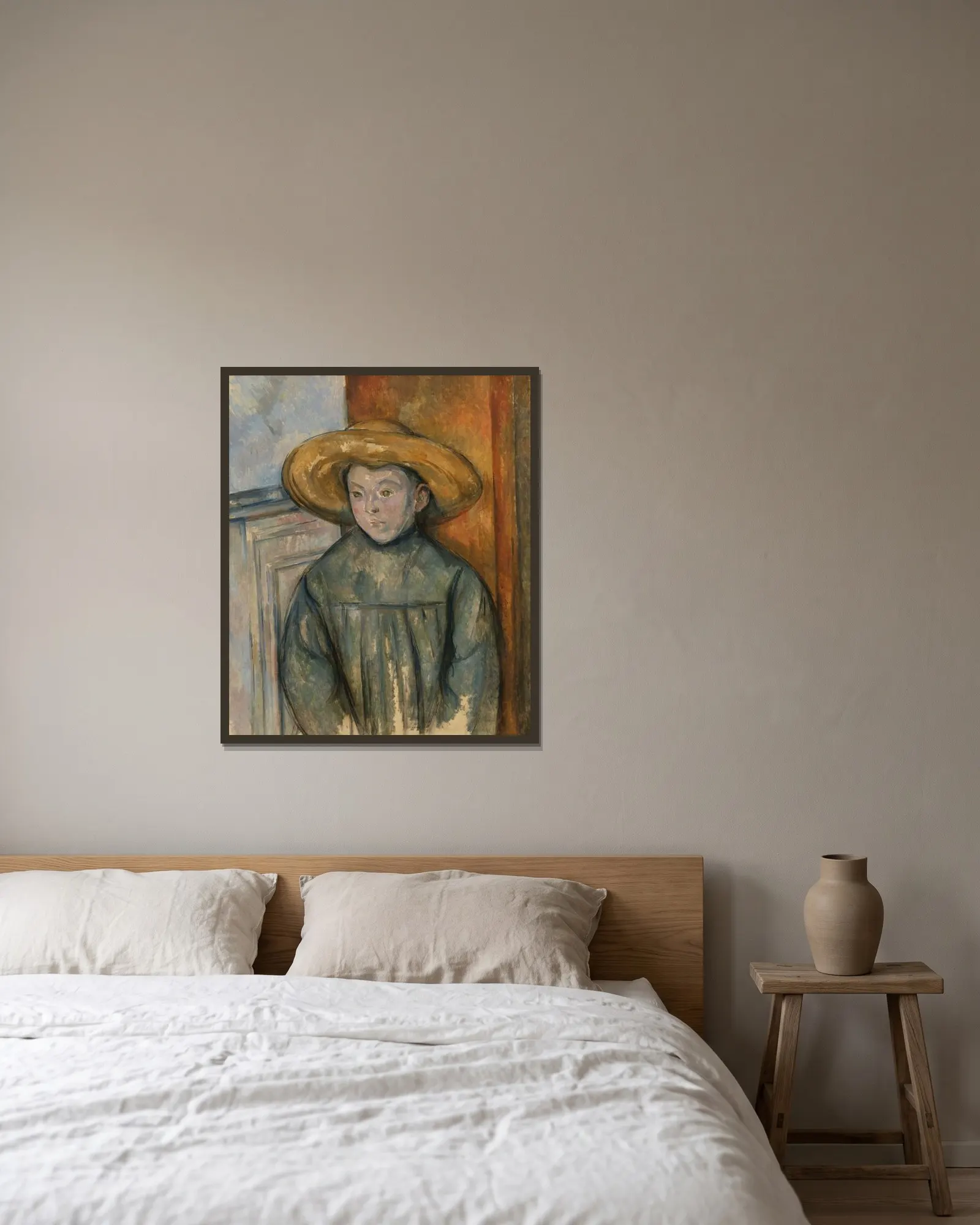 Boy With a Straw Hat av Paul Cézanne inramad på en vägg