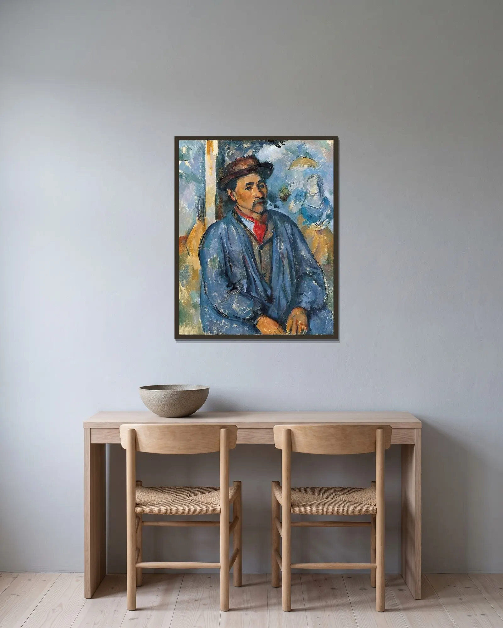 Man in a Blue Smock av Paul Cézanne inramad på en vägg