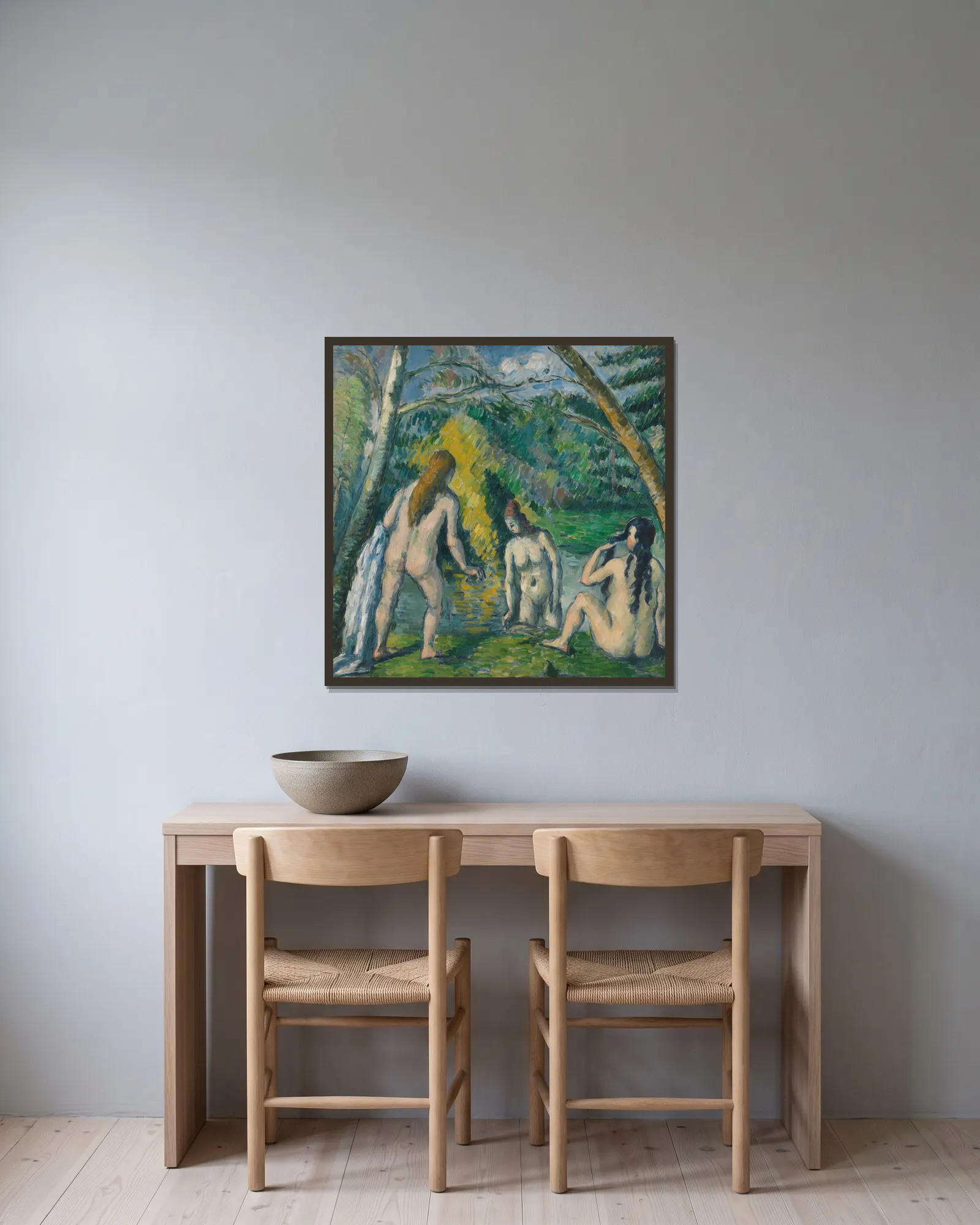 Trois baigneuses av Paul Cézanne inramad på en vägg