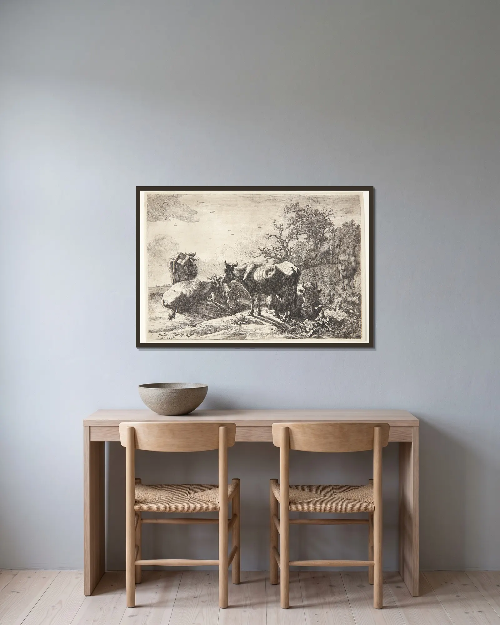 Kohyrden av Paulus Potter inramad på en vägg