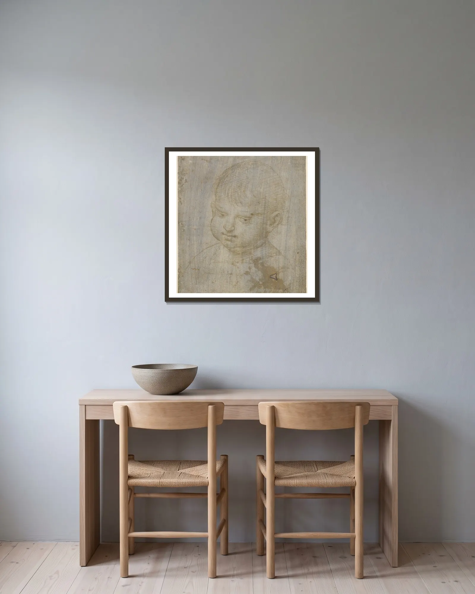 A child’s head av Raphael inramad på en vägg