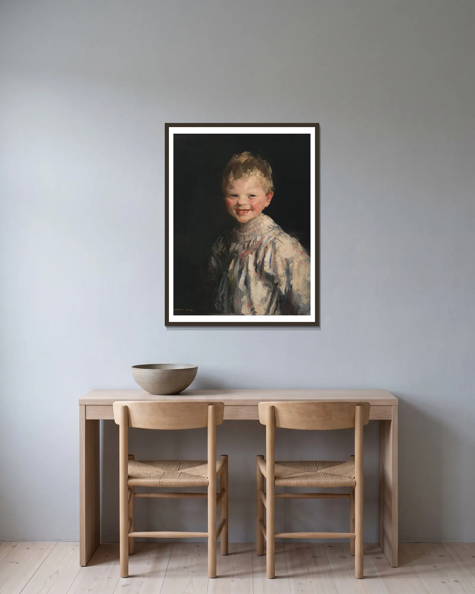 Laughing Child av Robert Henri inramad på en vägg