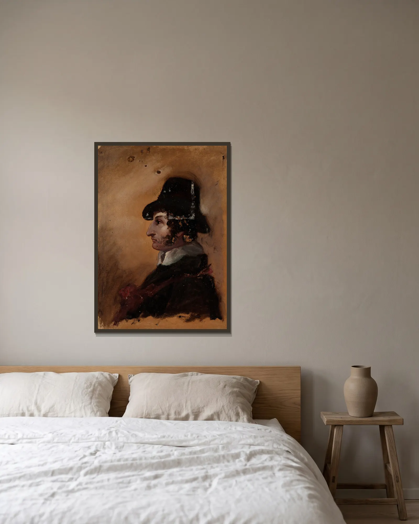 Man in a High Hat av Thomas Cole inramad på en vägg