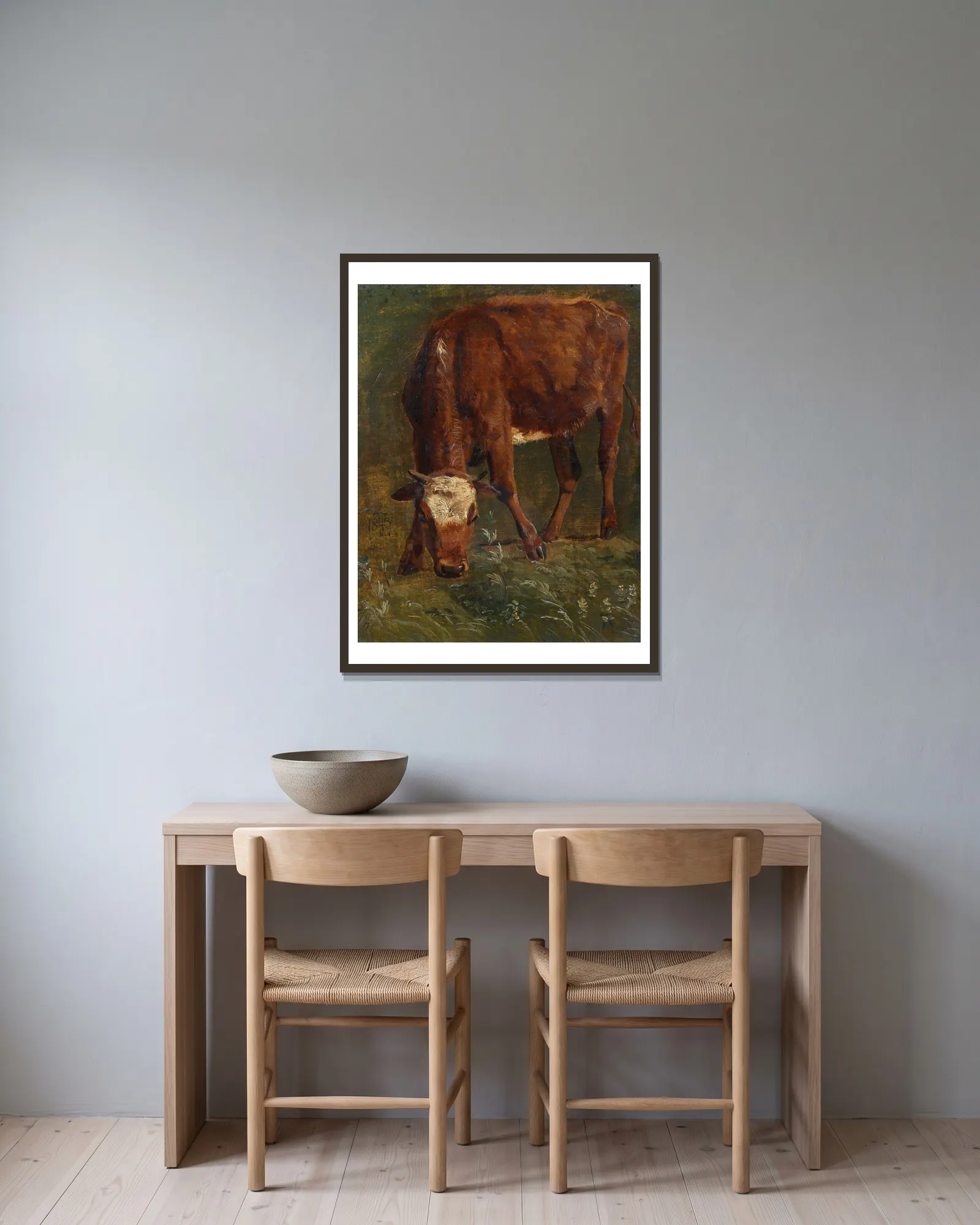 Grazing red heifer. Study av Johan Thomas Lundbye inramad på en vägg