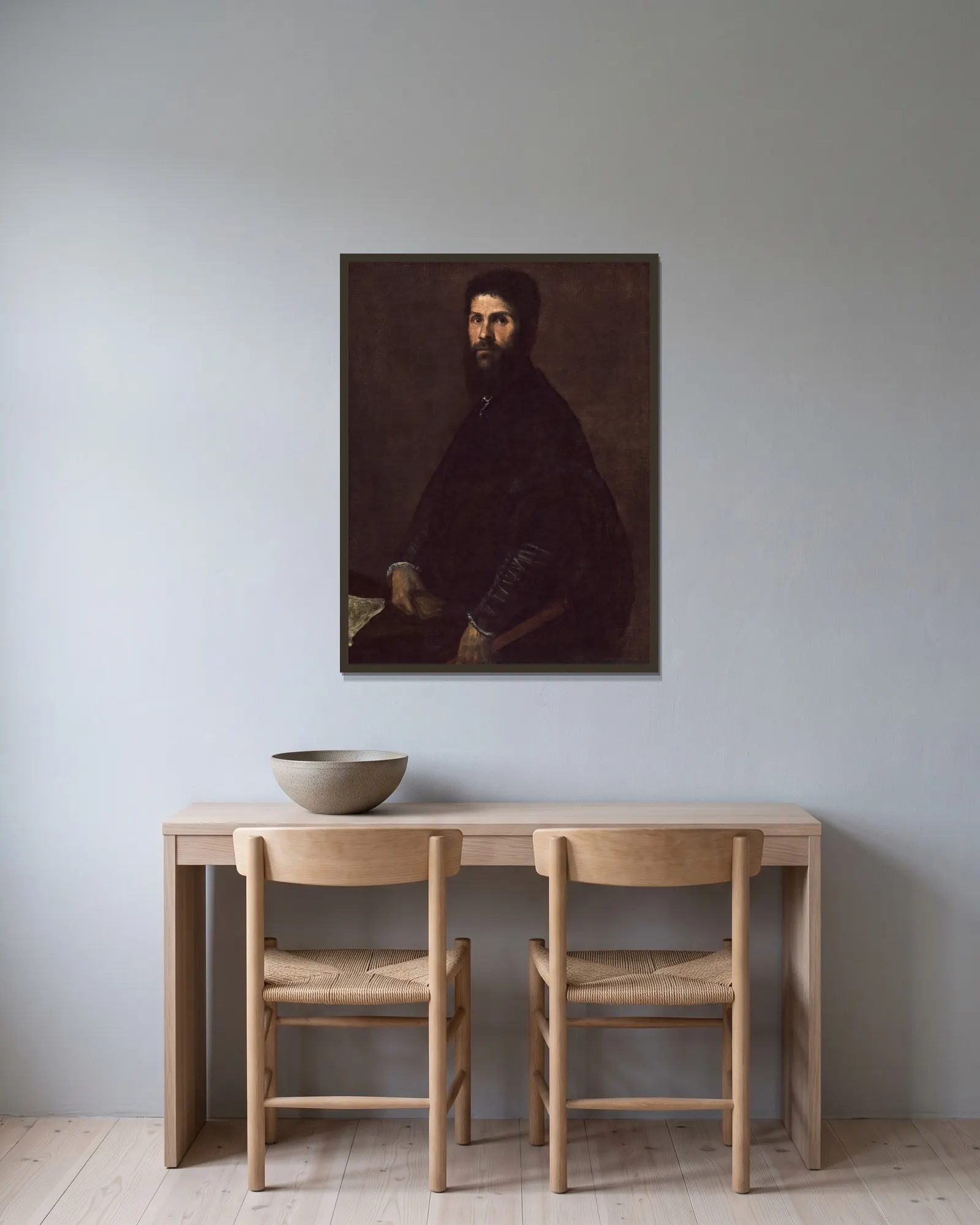 Man Holding a Flute av Titian inramad på en vägg