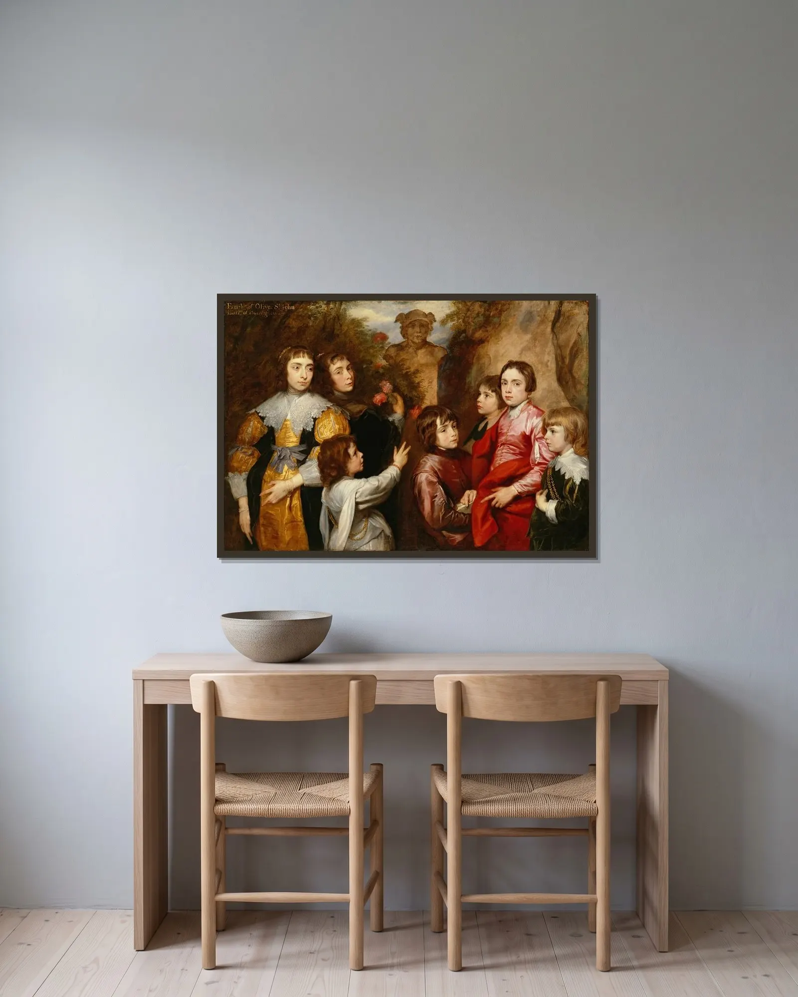 A Family Group av Anthony van Dyck inramad på en vägg