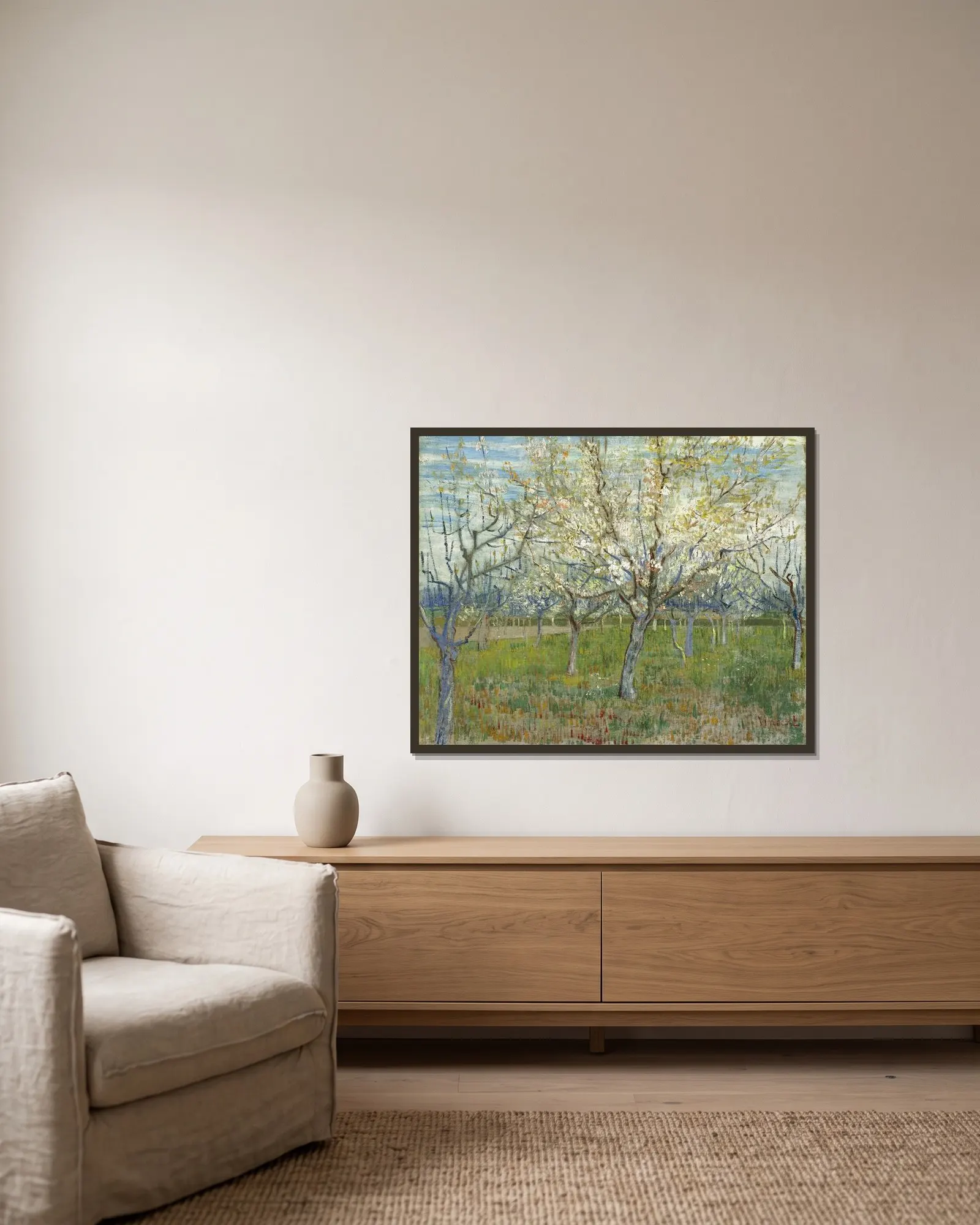 The Pink Orchard av Vincent van Gogh inramad på en vägg