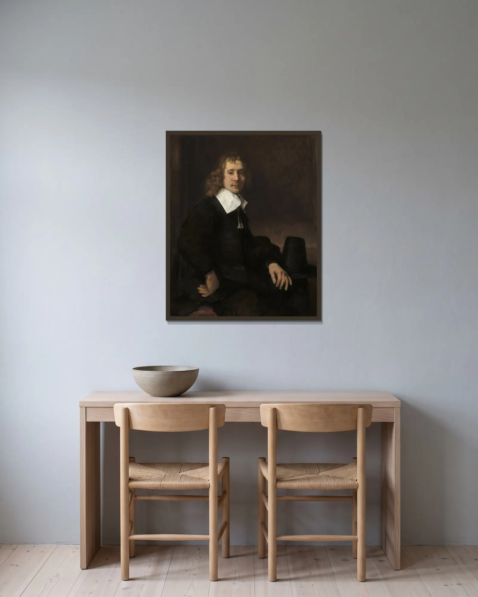 A Young Man Seated at a Table (possibly Govaert Flinck) av Rembrandt van Rijn inramad på en vägg