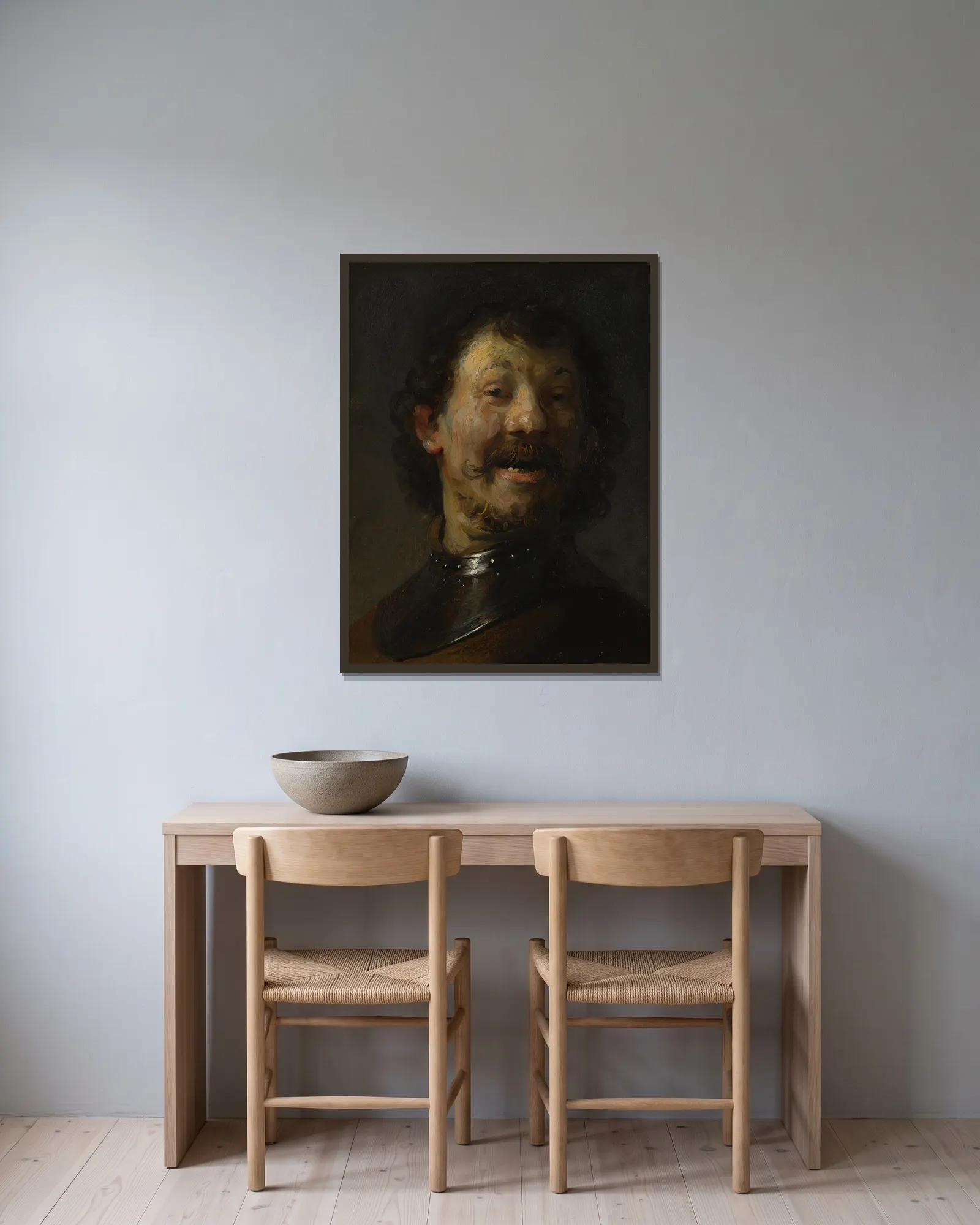 The Laughing Man av Rembrandt van Rijn inramad på en vägg